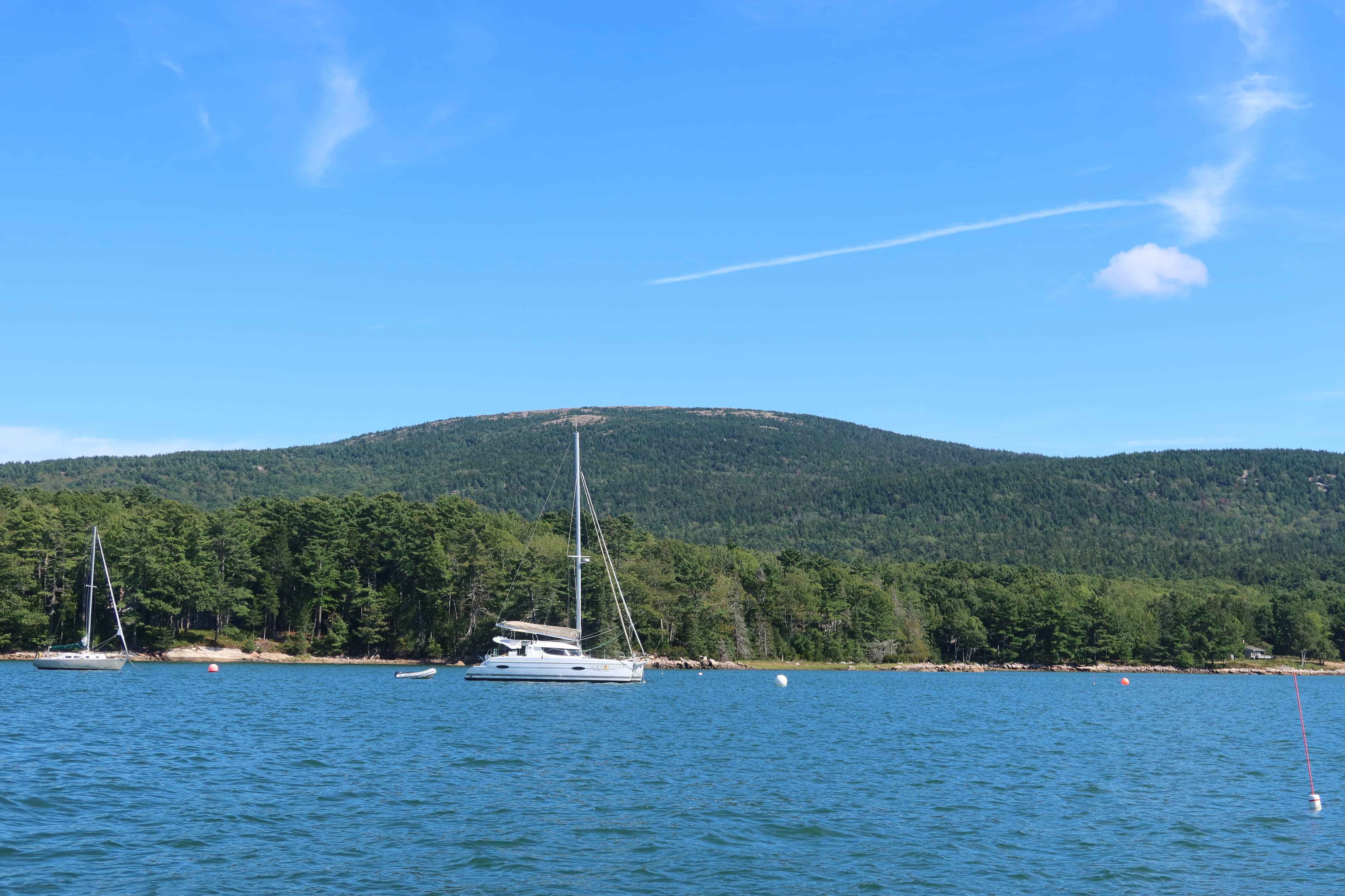 A yacht in the ocean on a sunny day. 