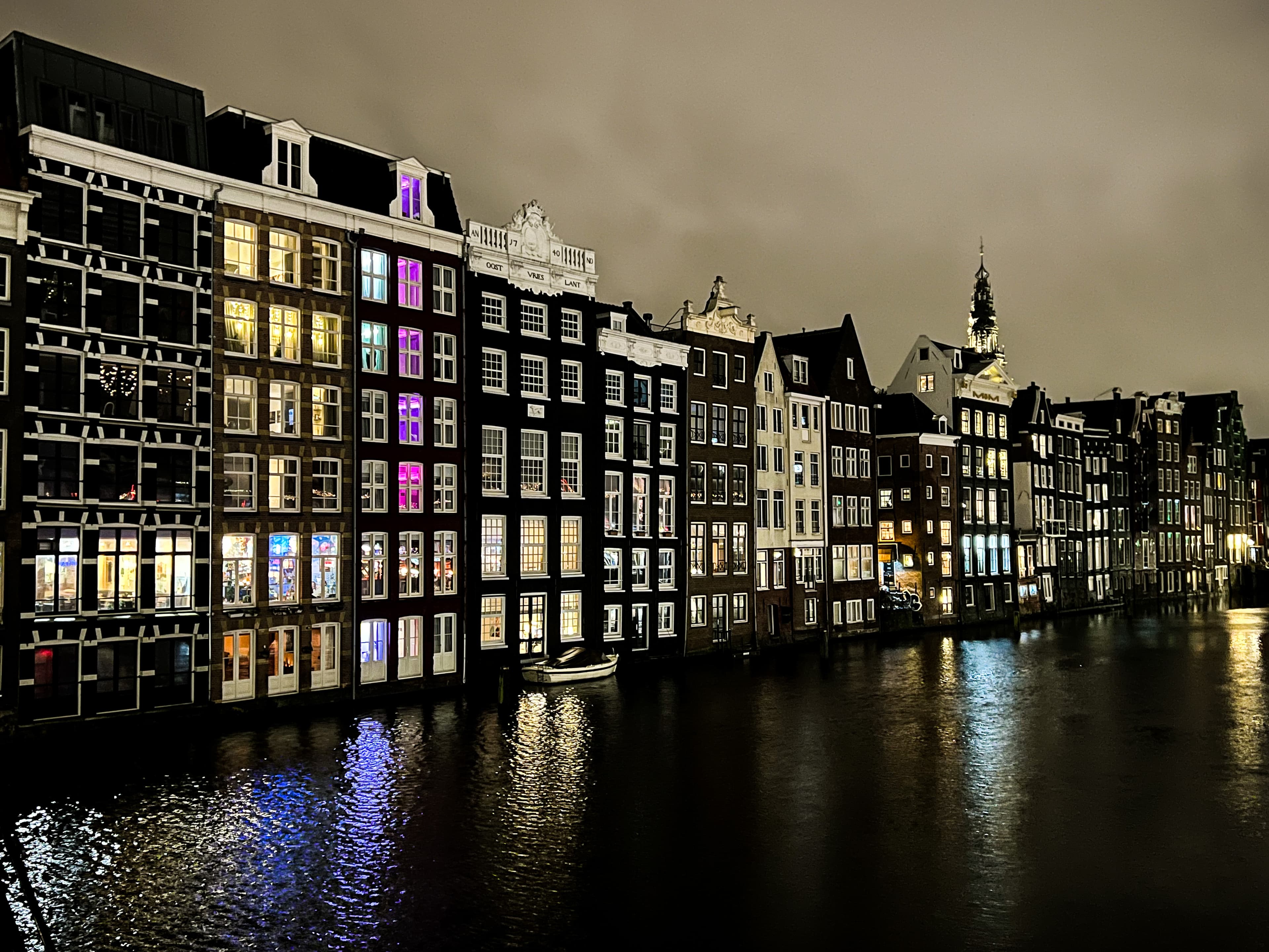 A view of buildings at night with a canal. 
