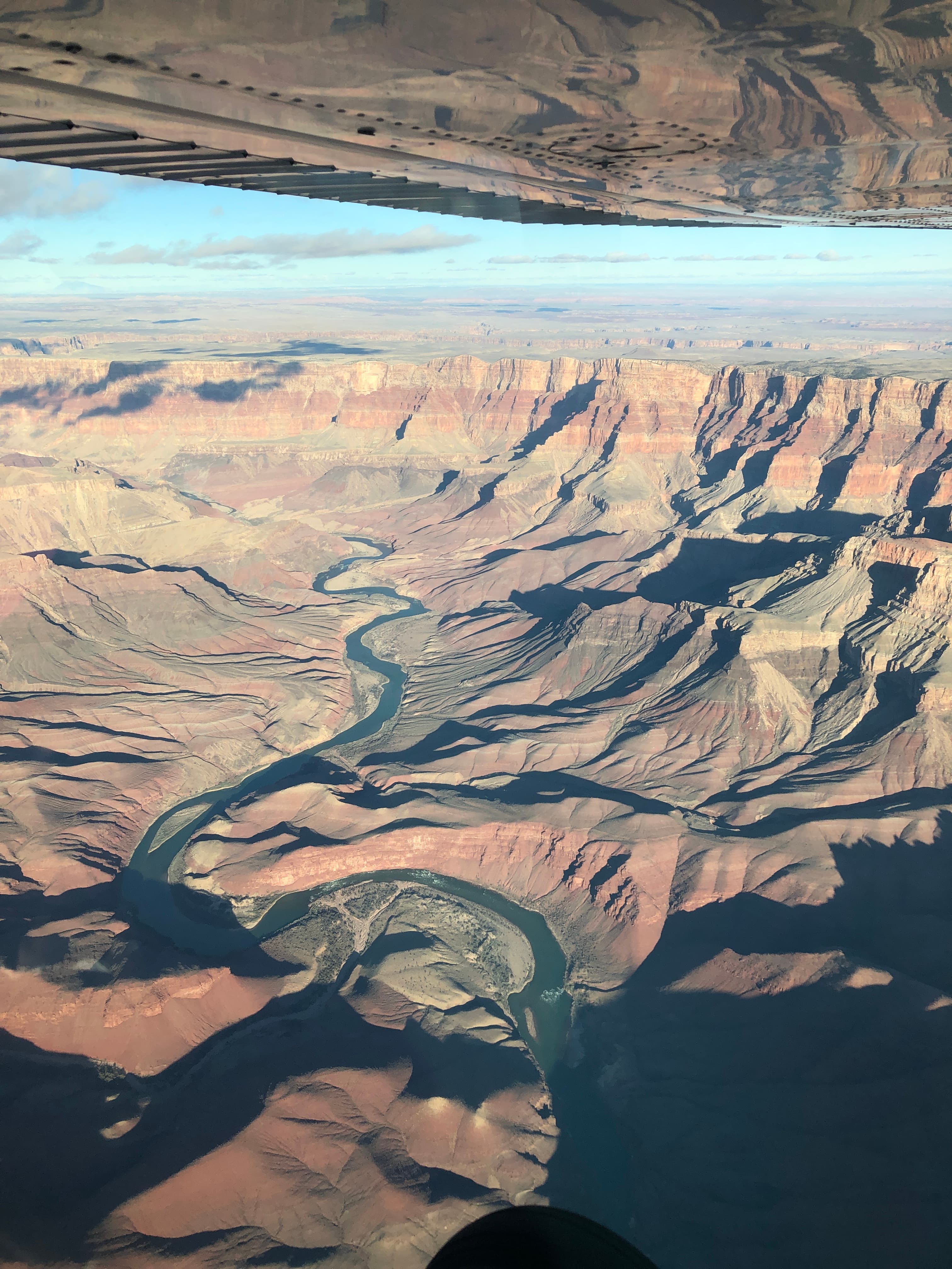 View from above of a beautiful river flowing through a canyon on a sunny day