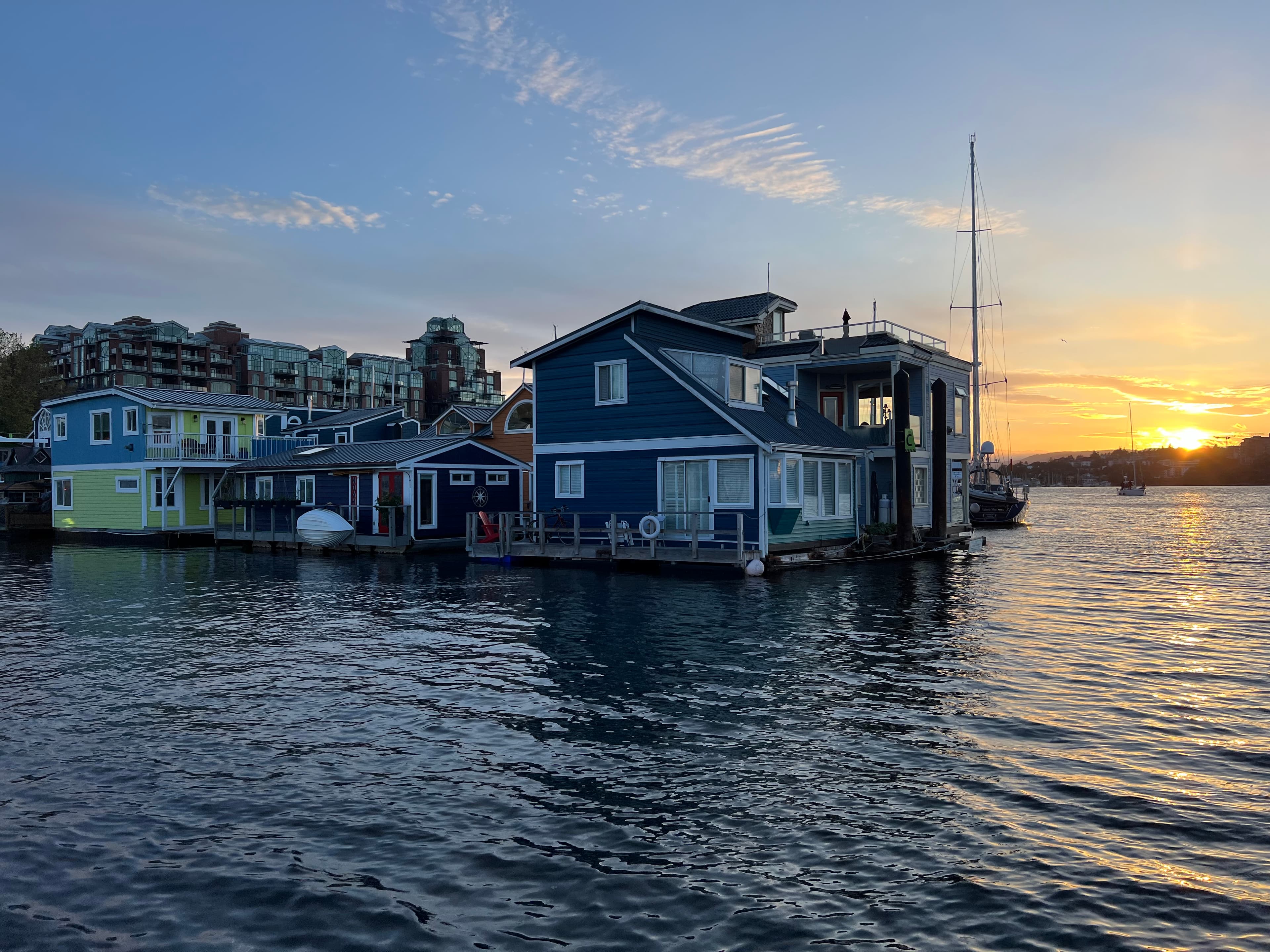 View of a small residential buildings right on the water at sunset
