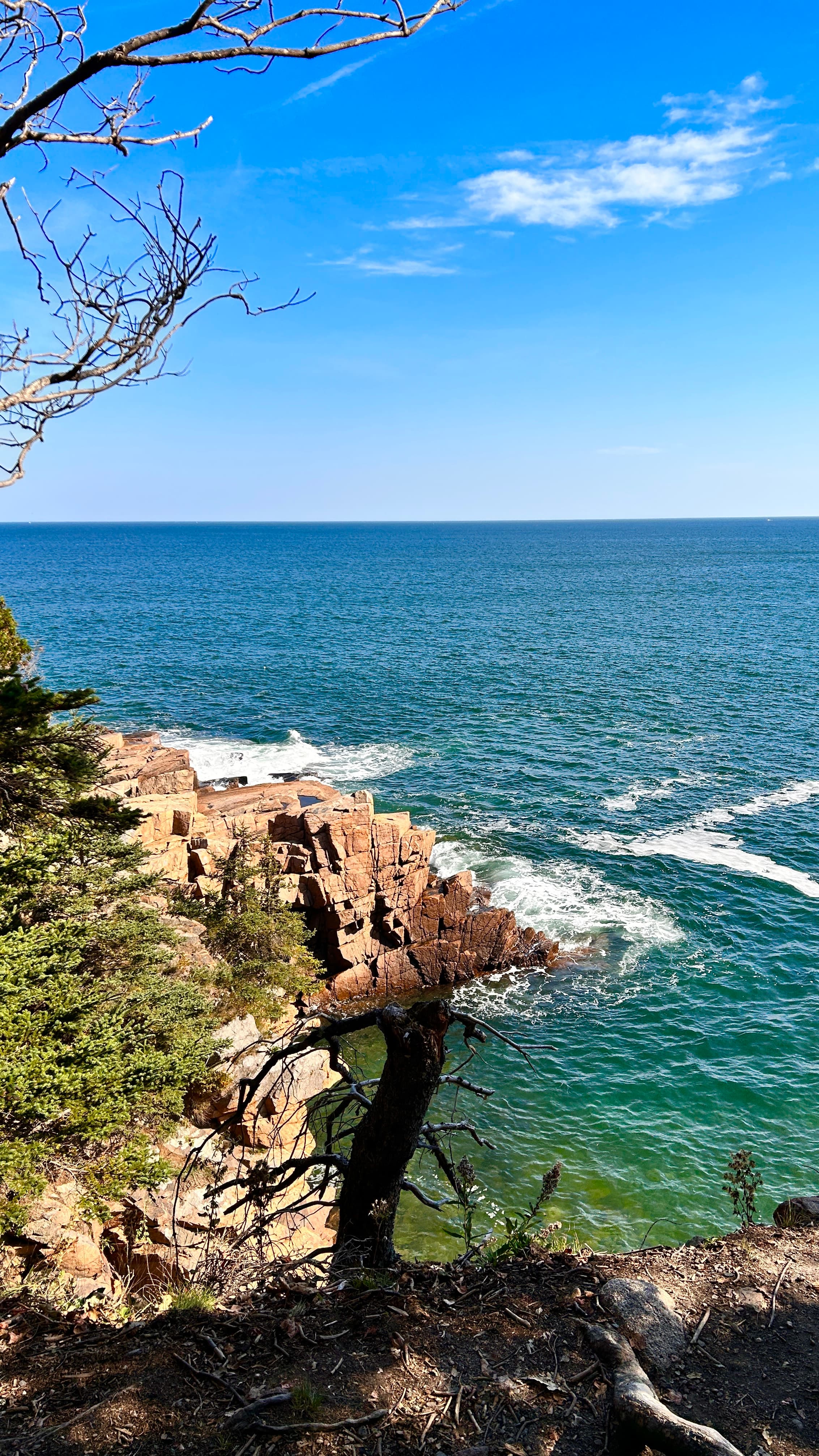 View the sea and rocky cliffs seen from the coast during the day