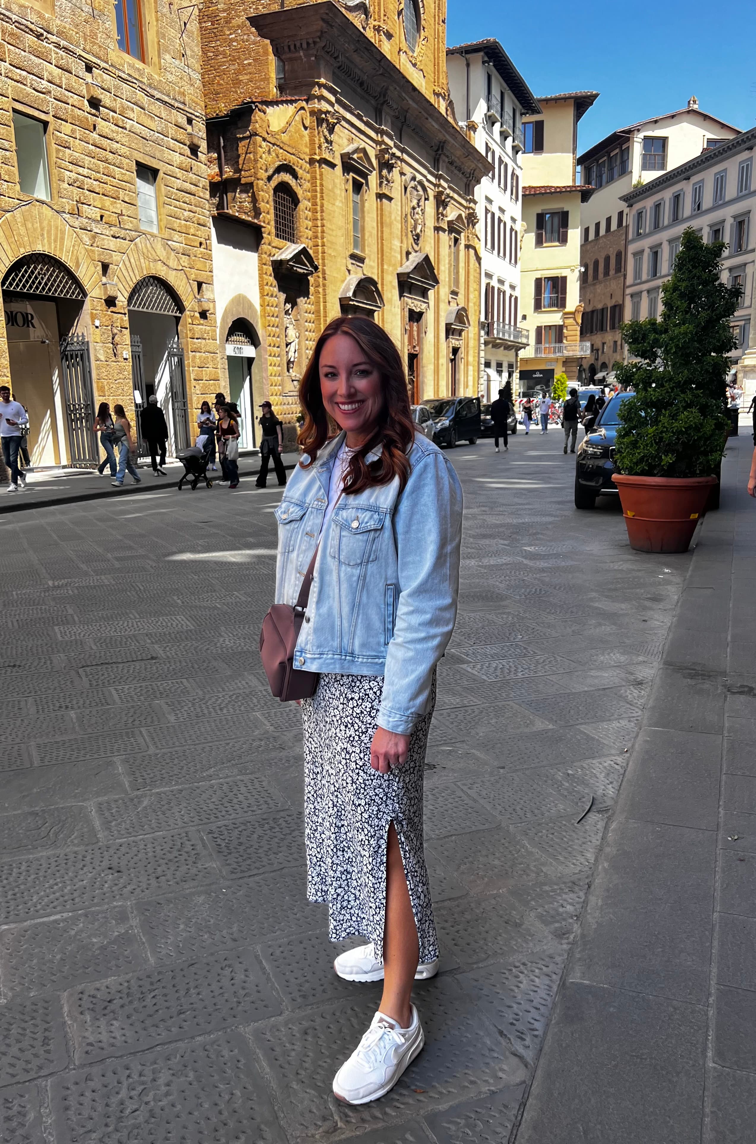 Standing in front of traditional buildings during the day.