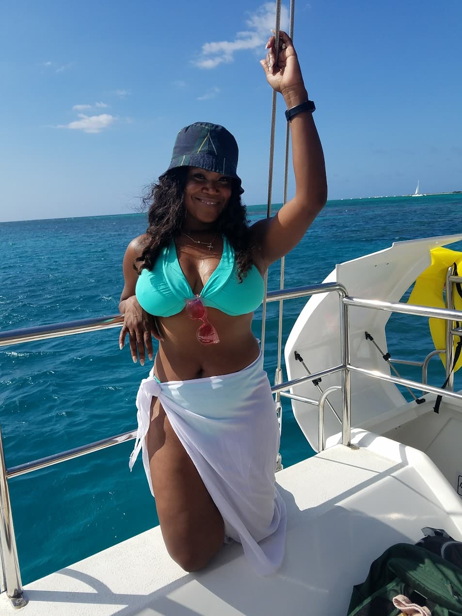 Advisor posing in a swimsuit on a boat in the ocean on a sunny day. 
