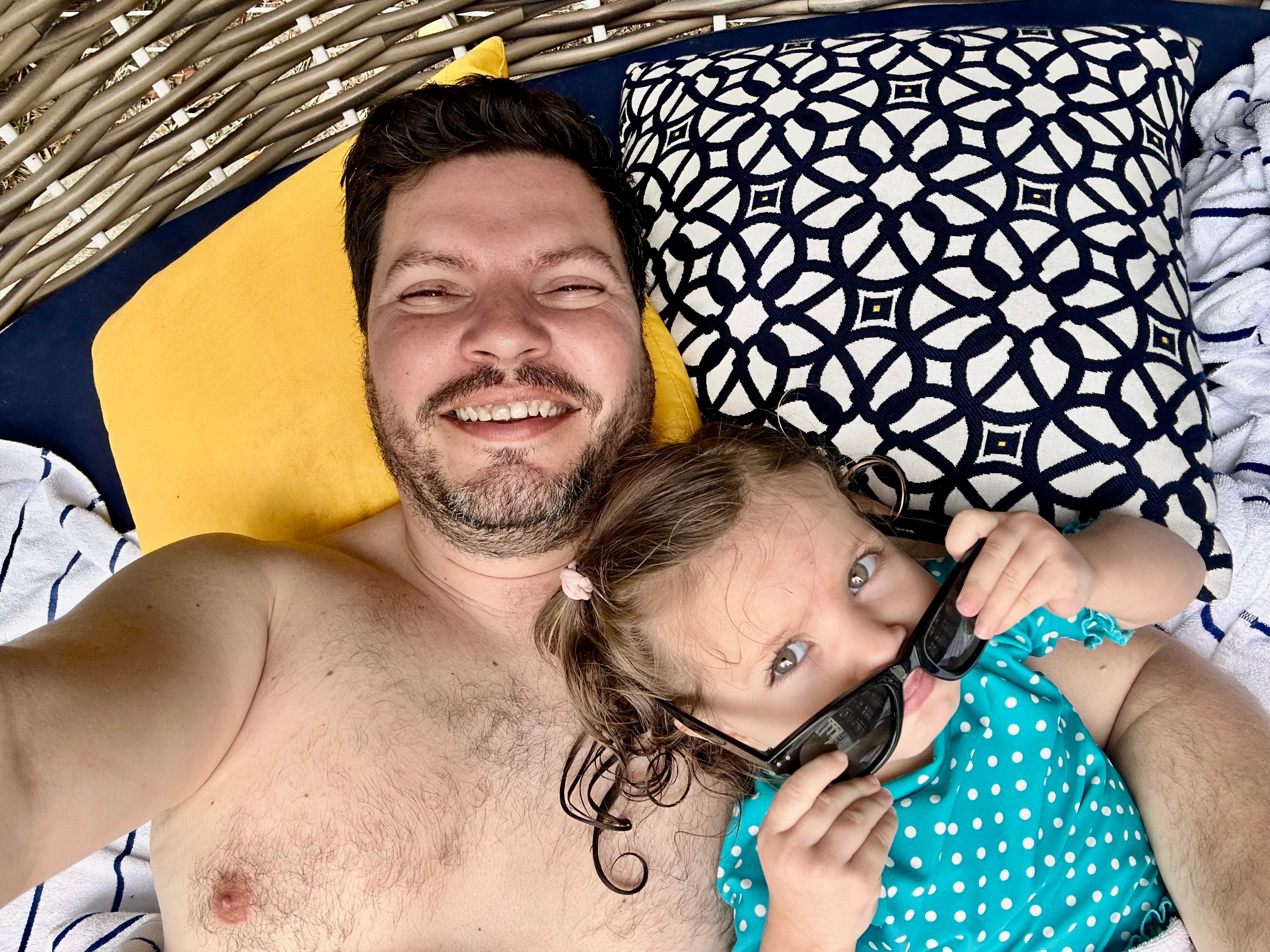 Advisor and his daughter taking a selfie on a lounge chair