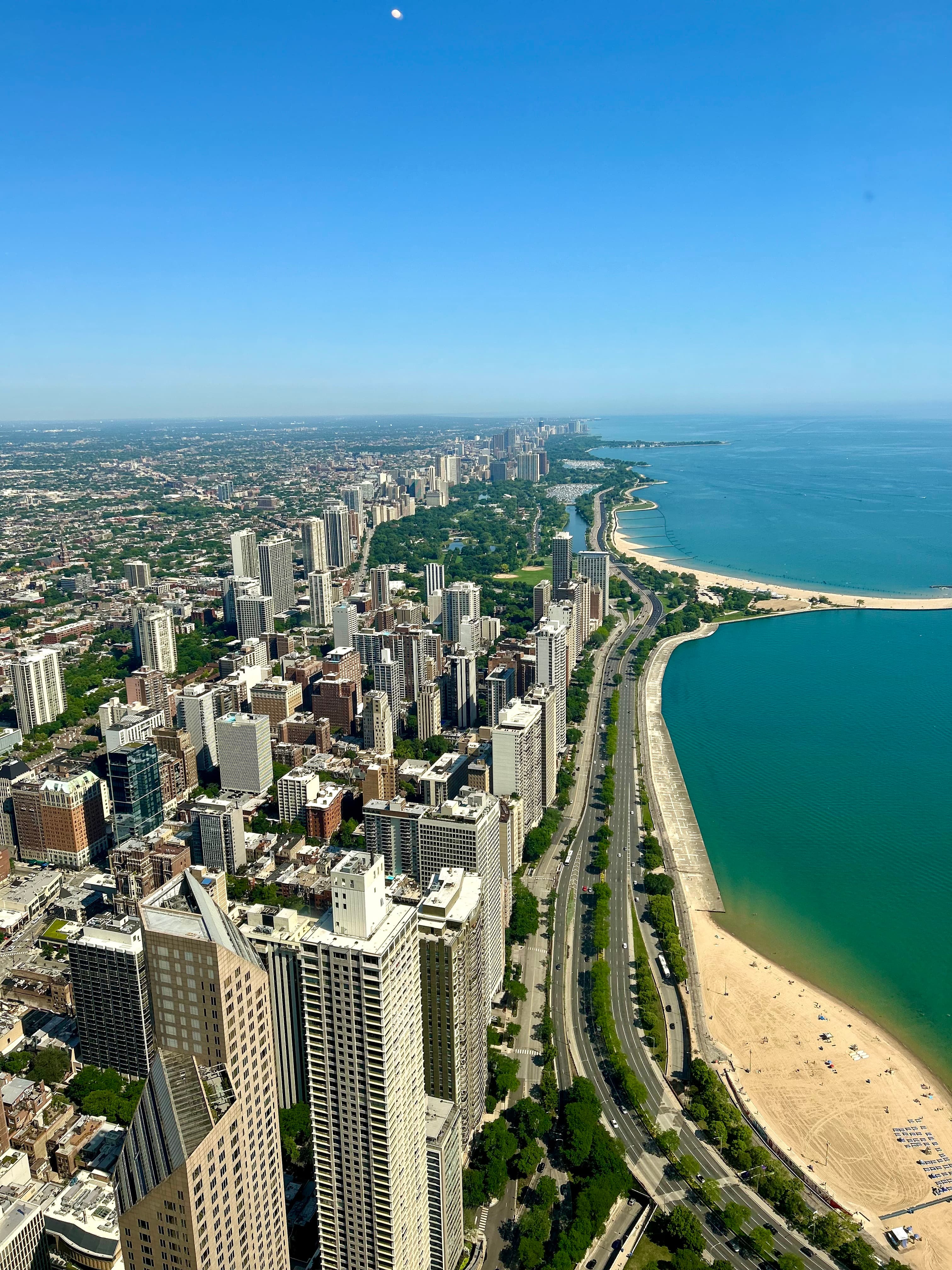 Overhead view of an ocean-side city skyline with beaches.