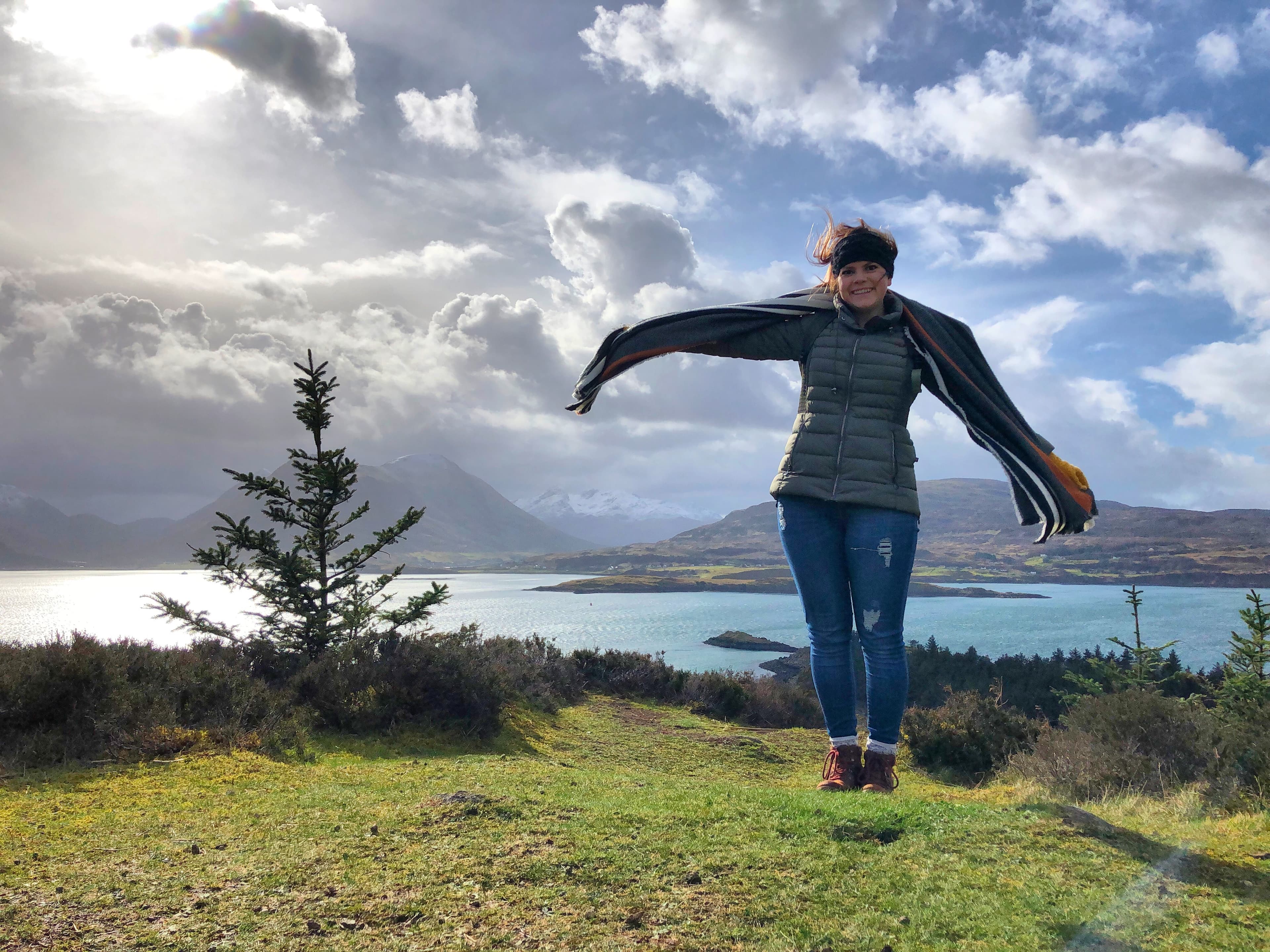 Advisor on a hike overlooking a beautiful coastal landscape on a sunny day