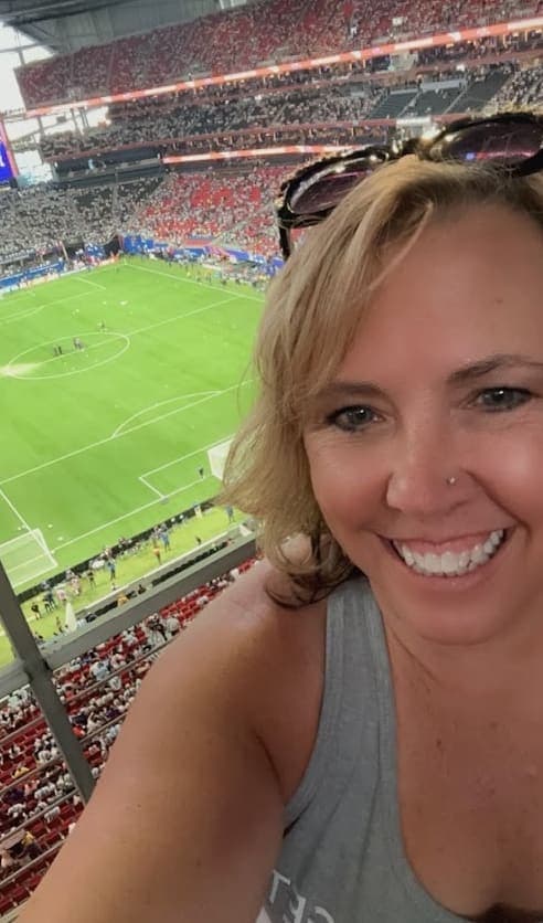 Advisor taking a selfie inside a large stadium sport event