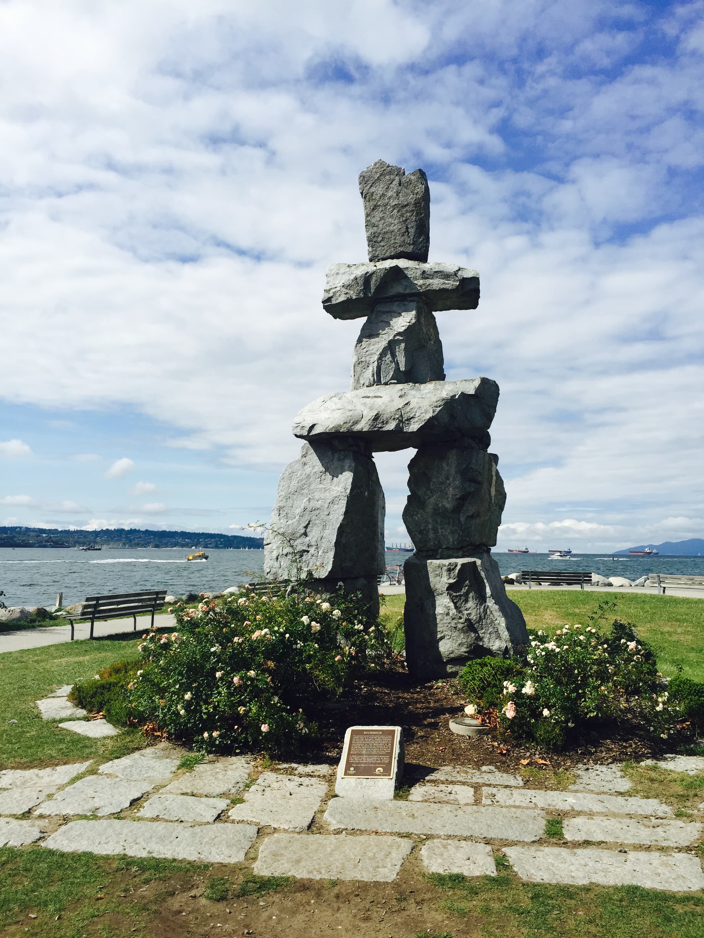 View of a small tower of stacked stones in a park by the sea