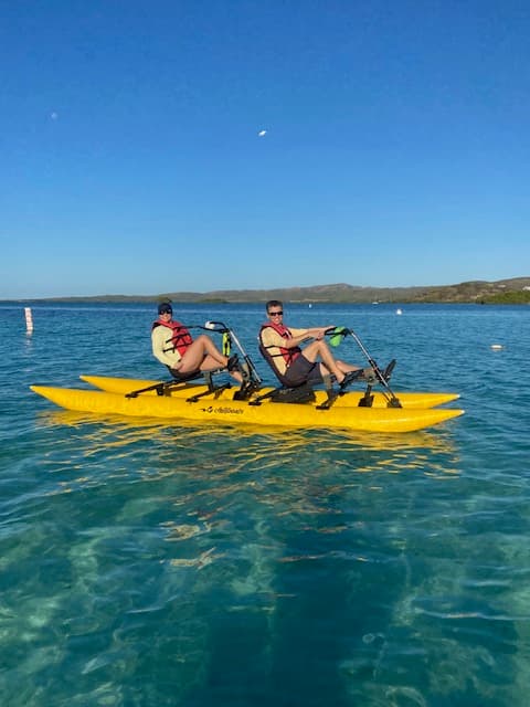 Monica and friend on a yellow canoe in the water.