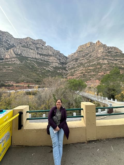Monica posing in front of mountains during the daytime.