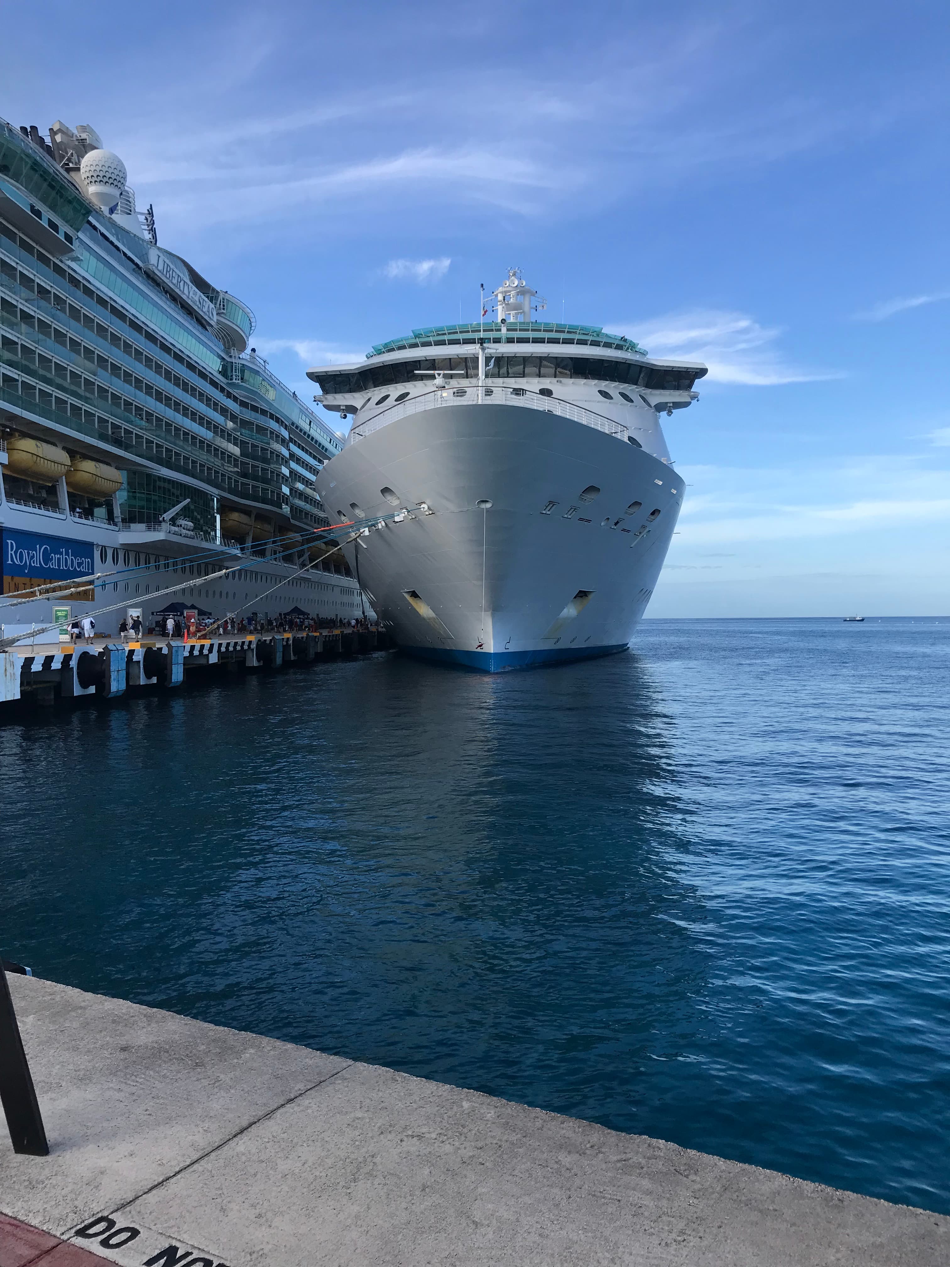 A cruise ship docked alongside the ocean.