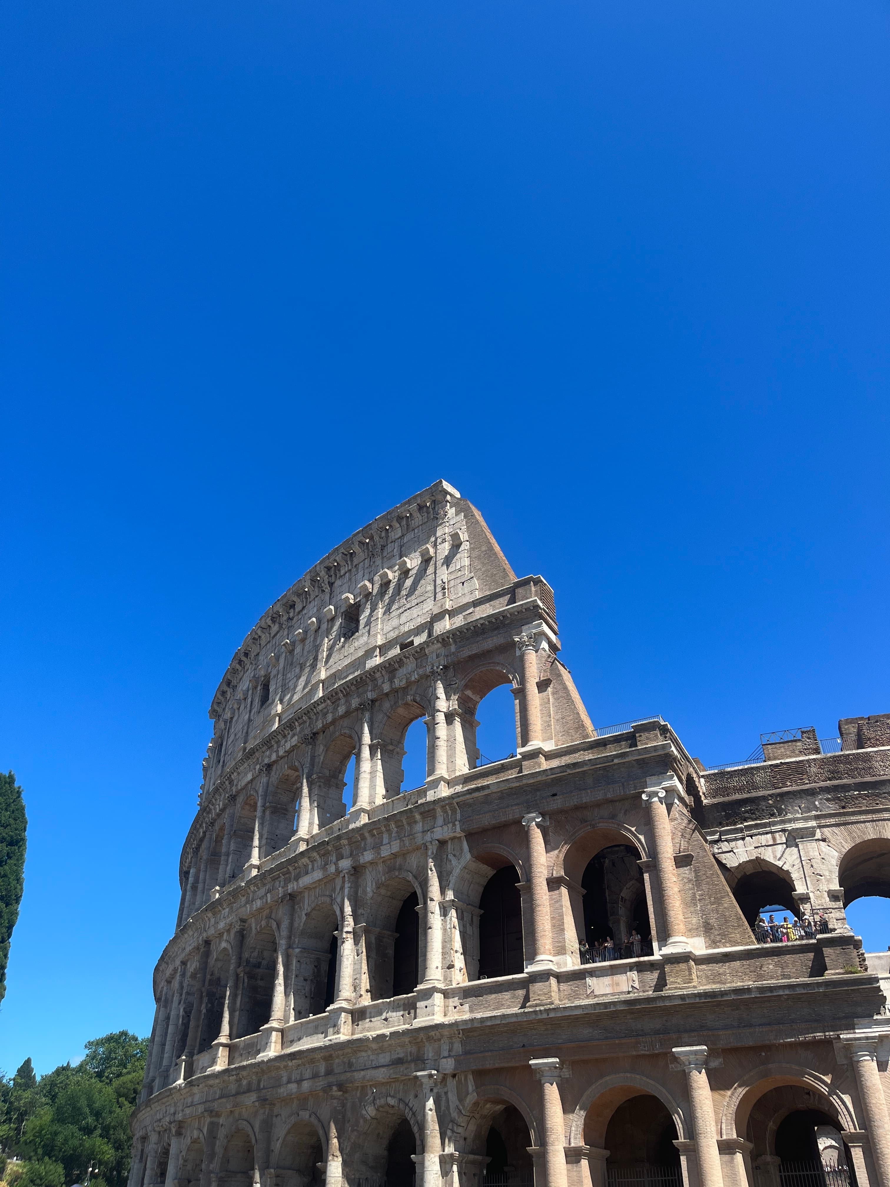 The Coliseum against a bright blue sky.
