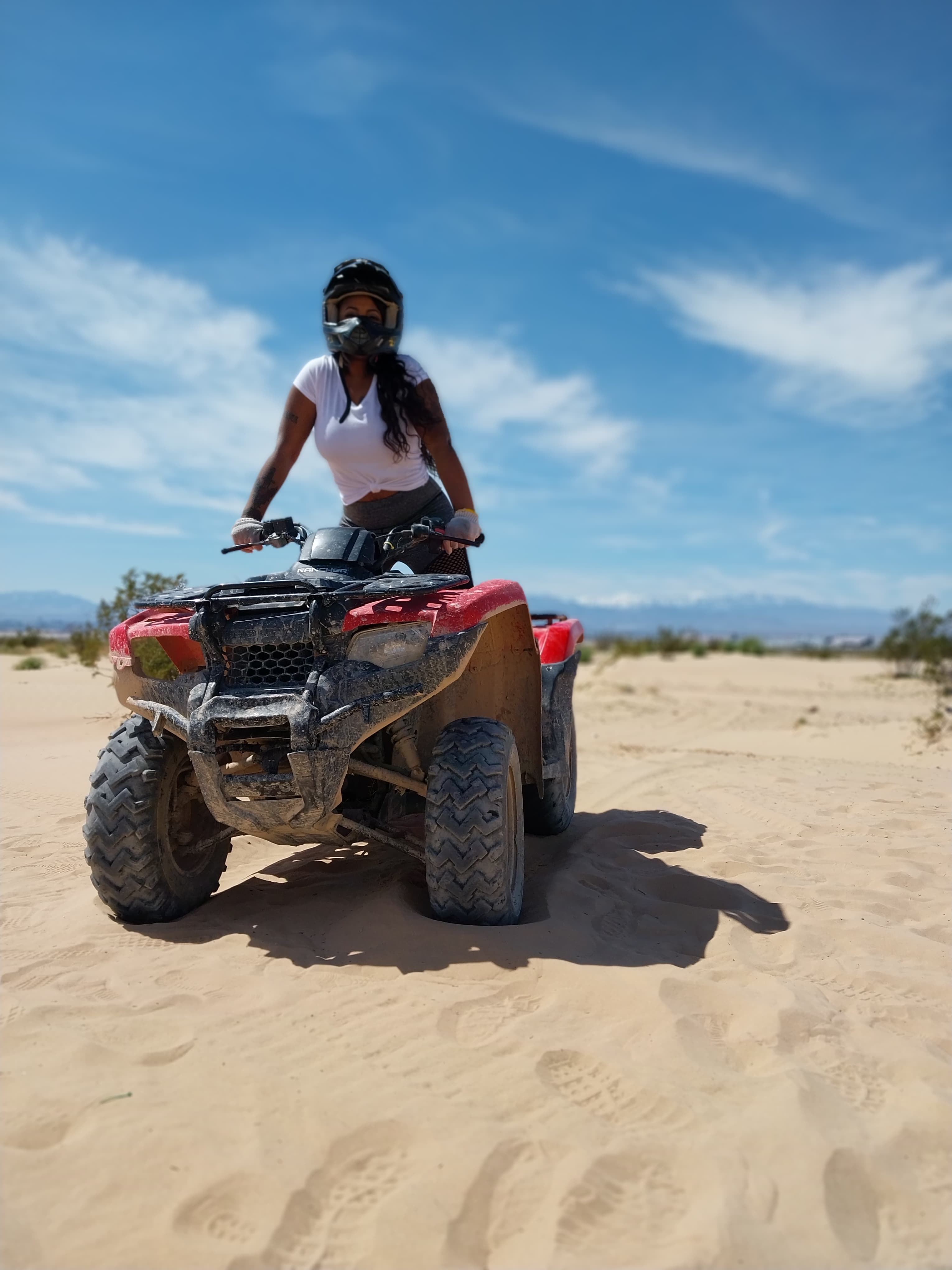 Advisor on an ATV inn the desert on a sunny day. 