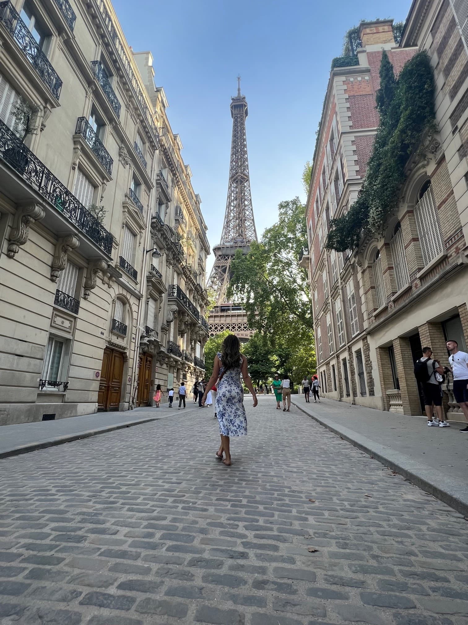 Advisor walking down the street with the Eiffel Tower in the distance. 
