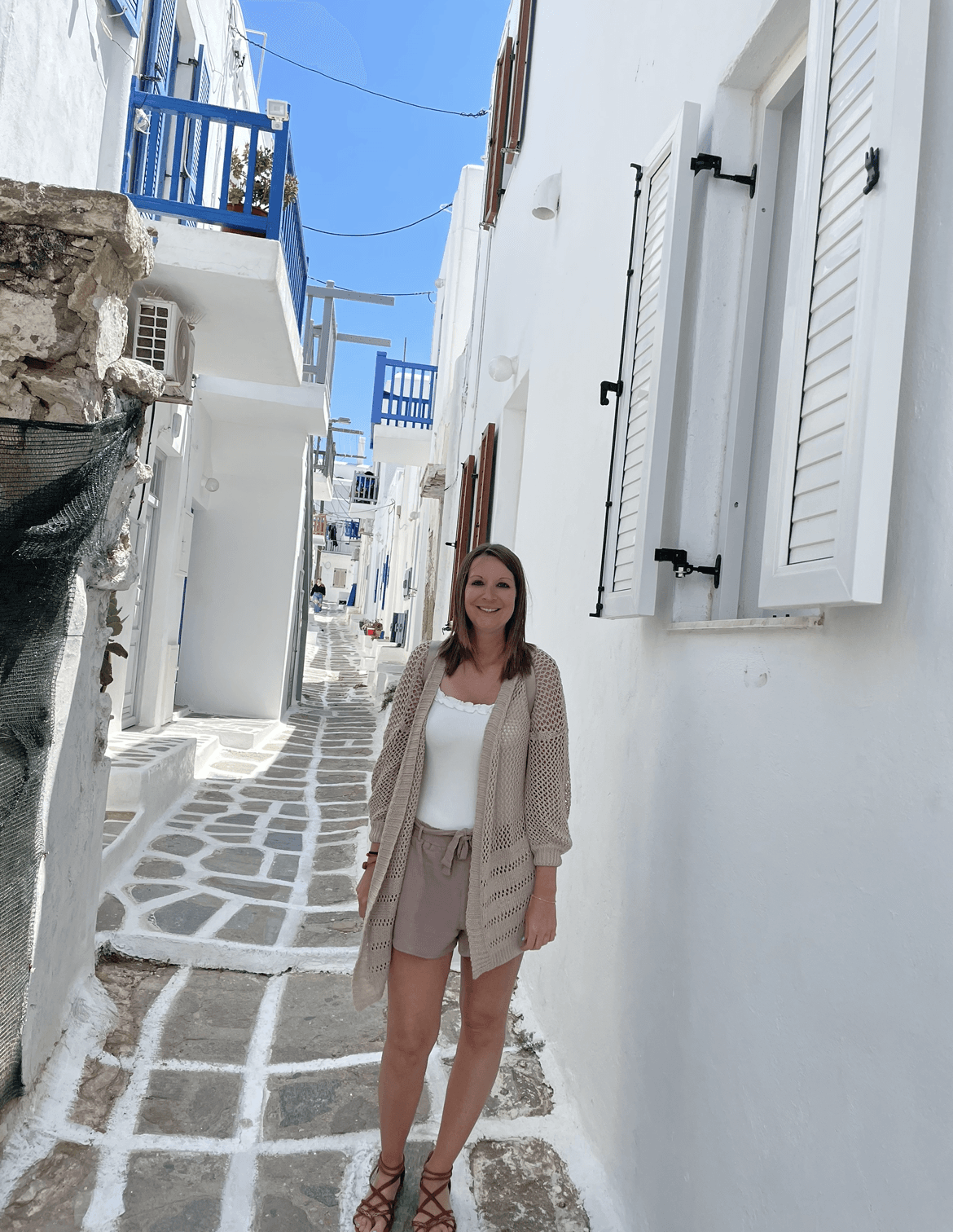 Advisor posing for a image with a white alleyway during the daytime. 