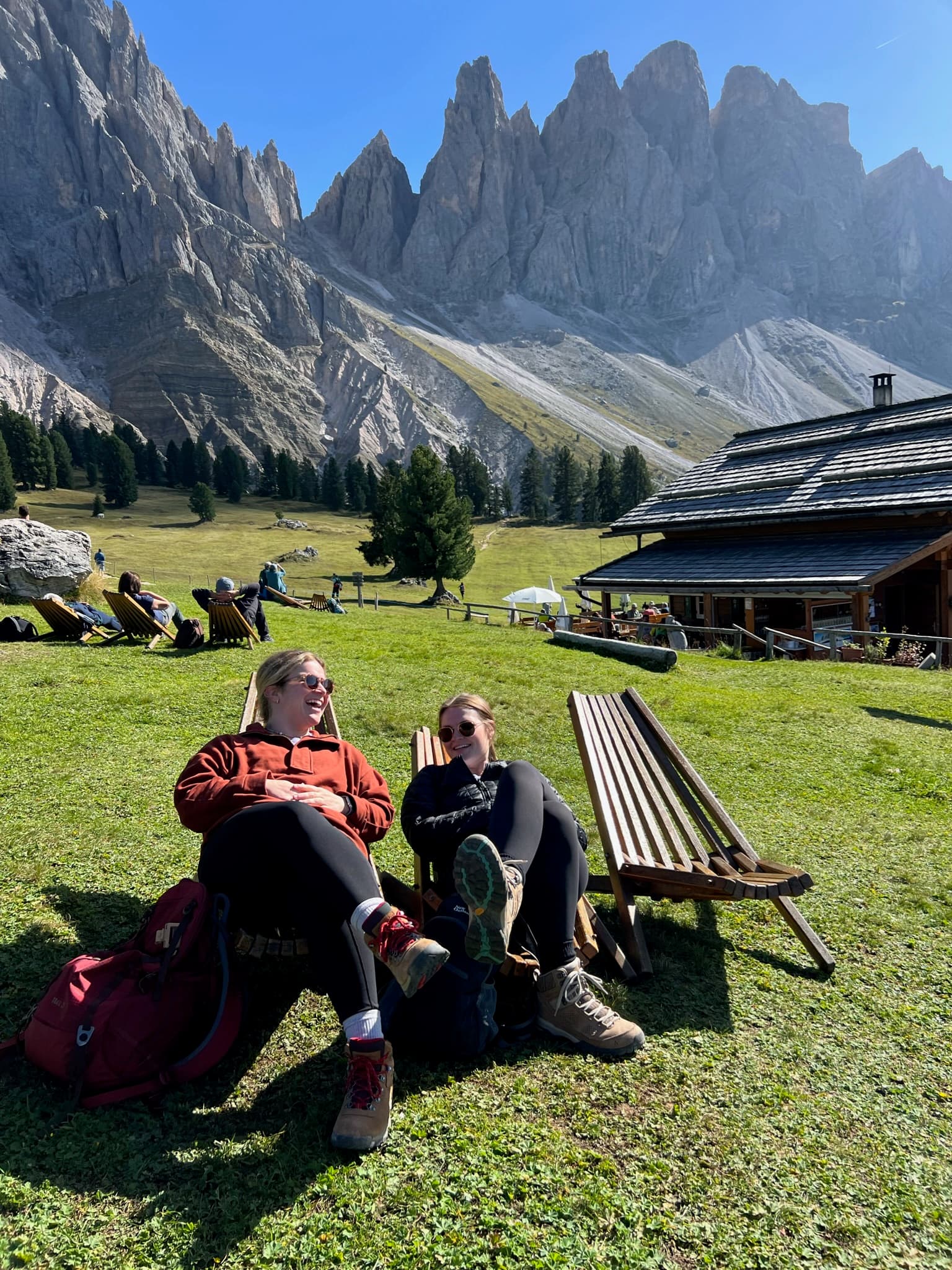 A couple sitting on lounge chairs in nature on a sunny day. 