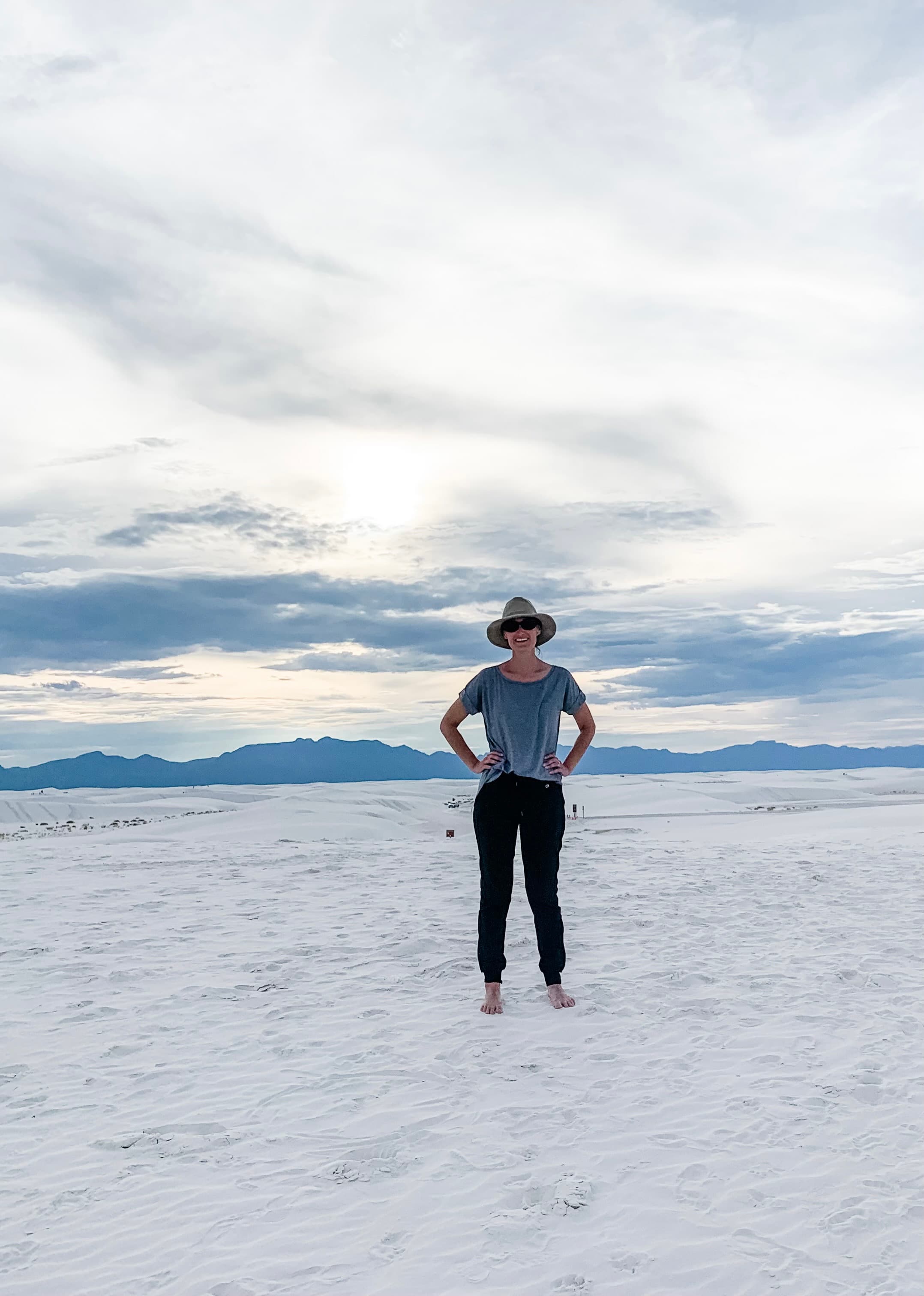 Advisor standing in a flat empty area with a mountain range visible on the horizon