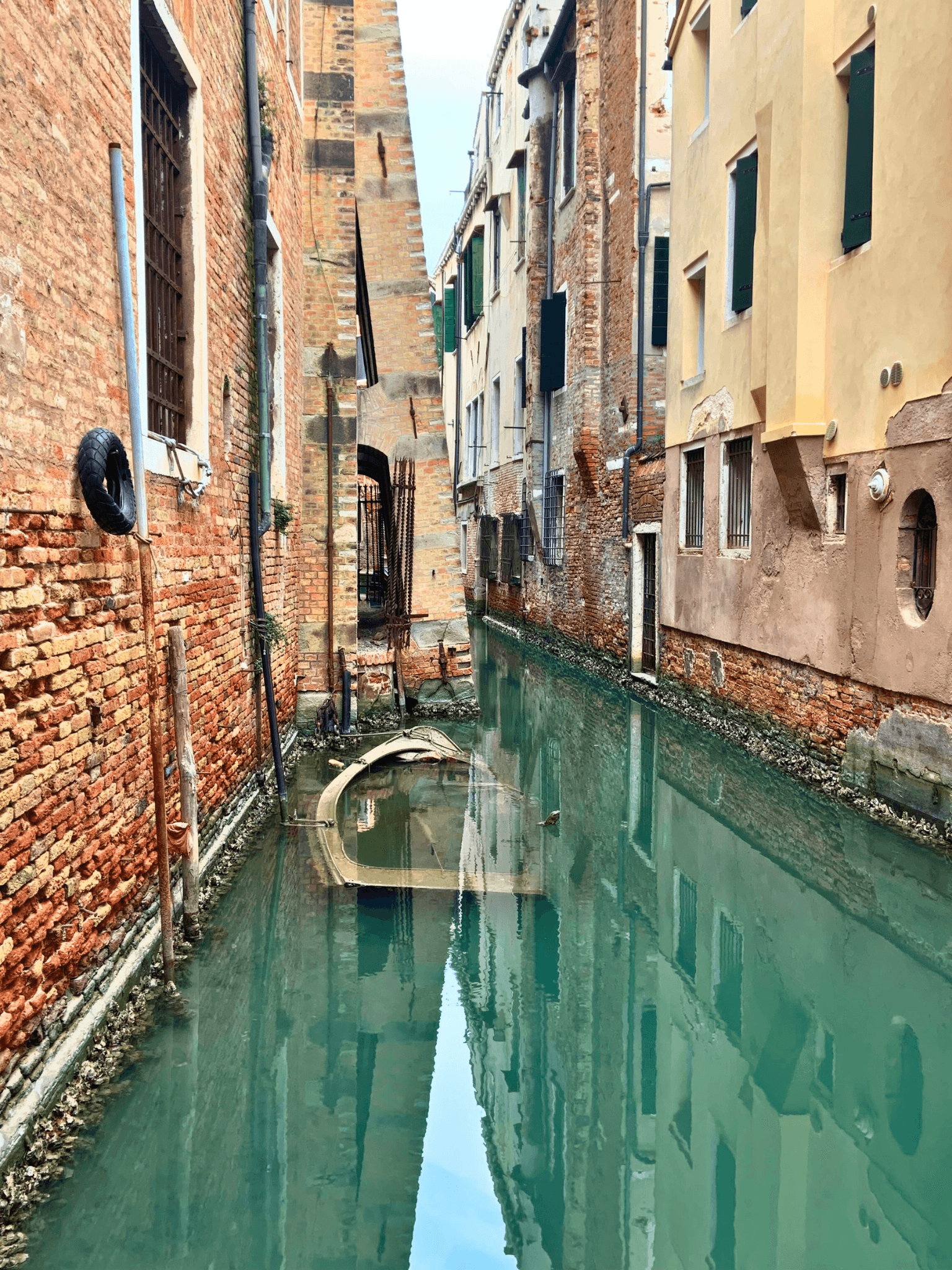 View of a glassy canal in Venice, Italy