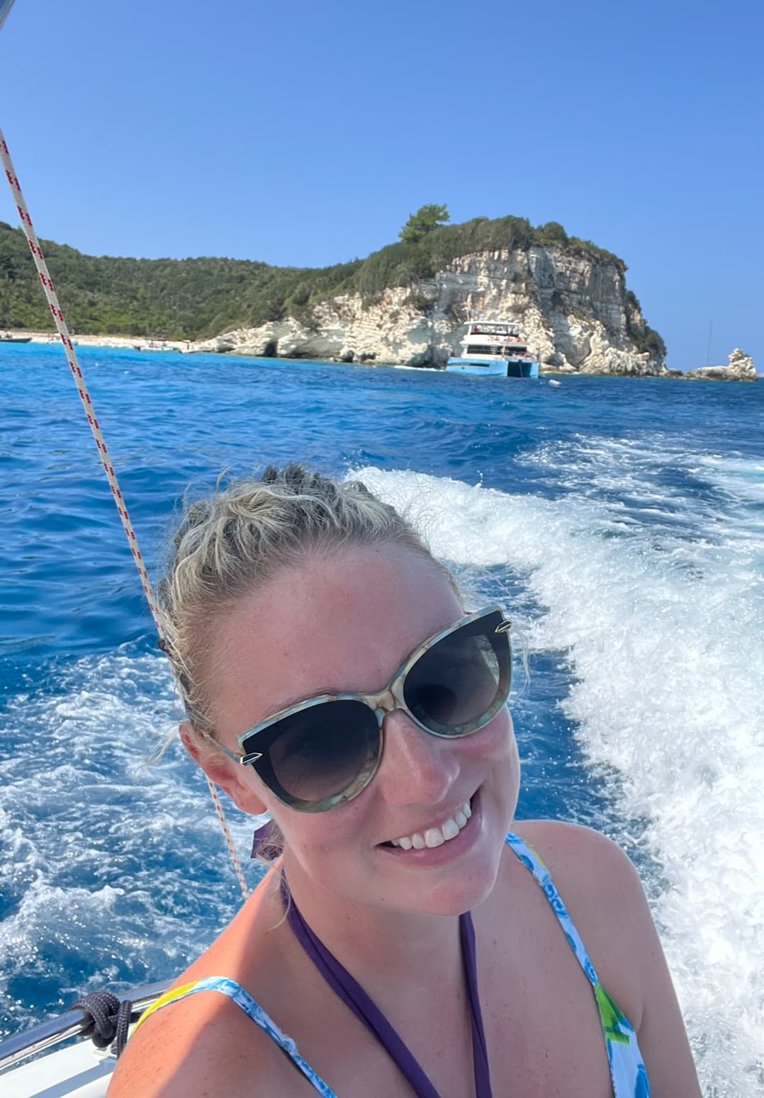 Advisor smiling on the back of a boat on a sunny day