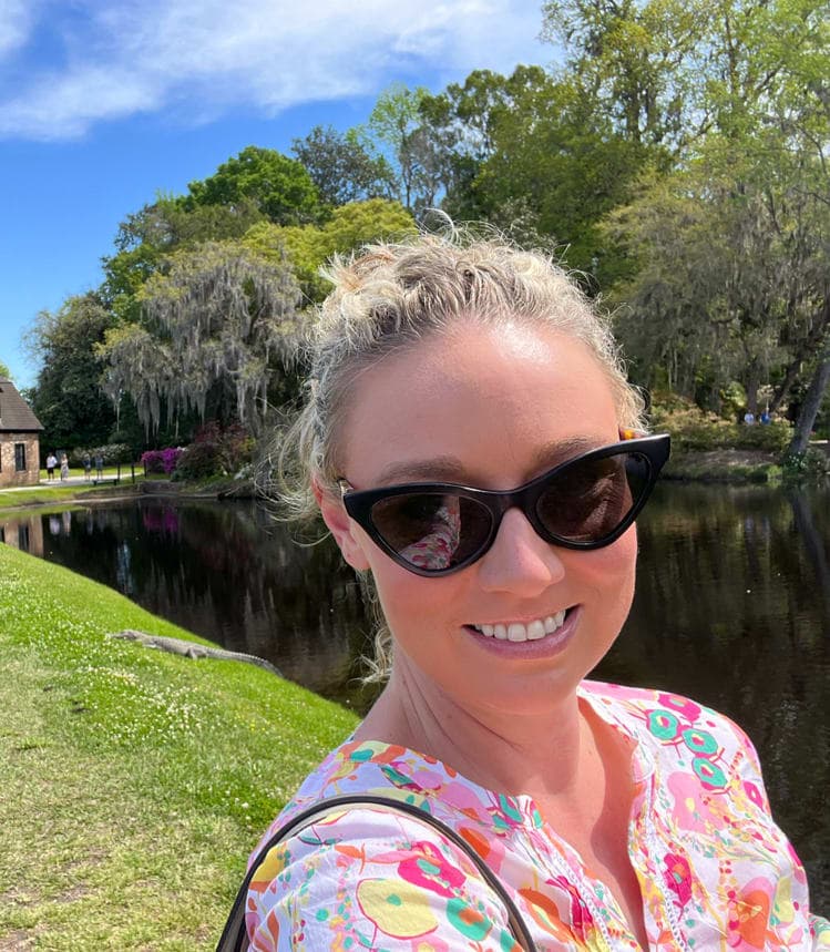 Advisor in sunglasses and floral shirt taking a selfie in a garden on a sunny day