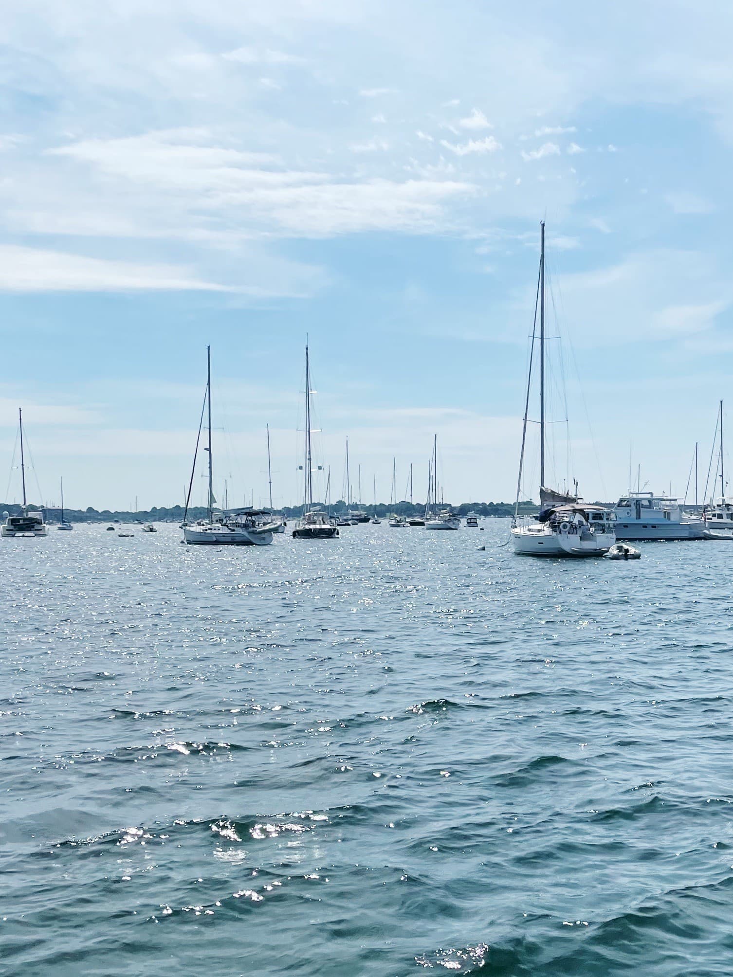 View of boats floating in a harbor on a sunny day 