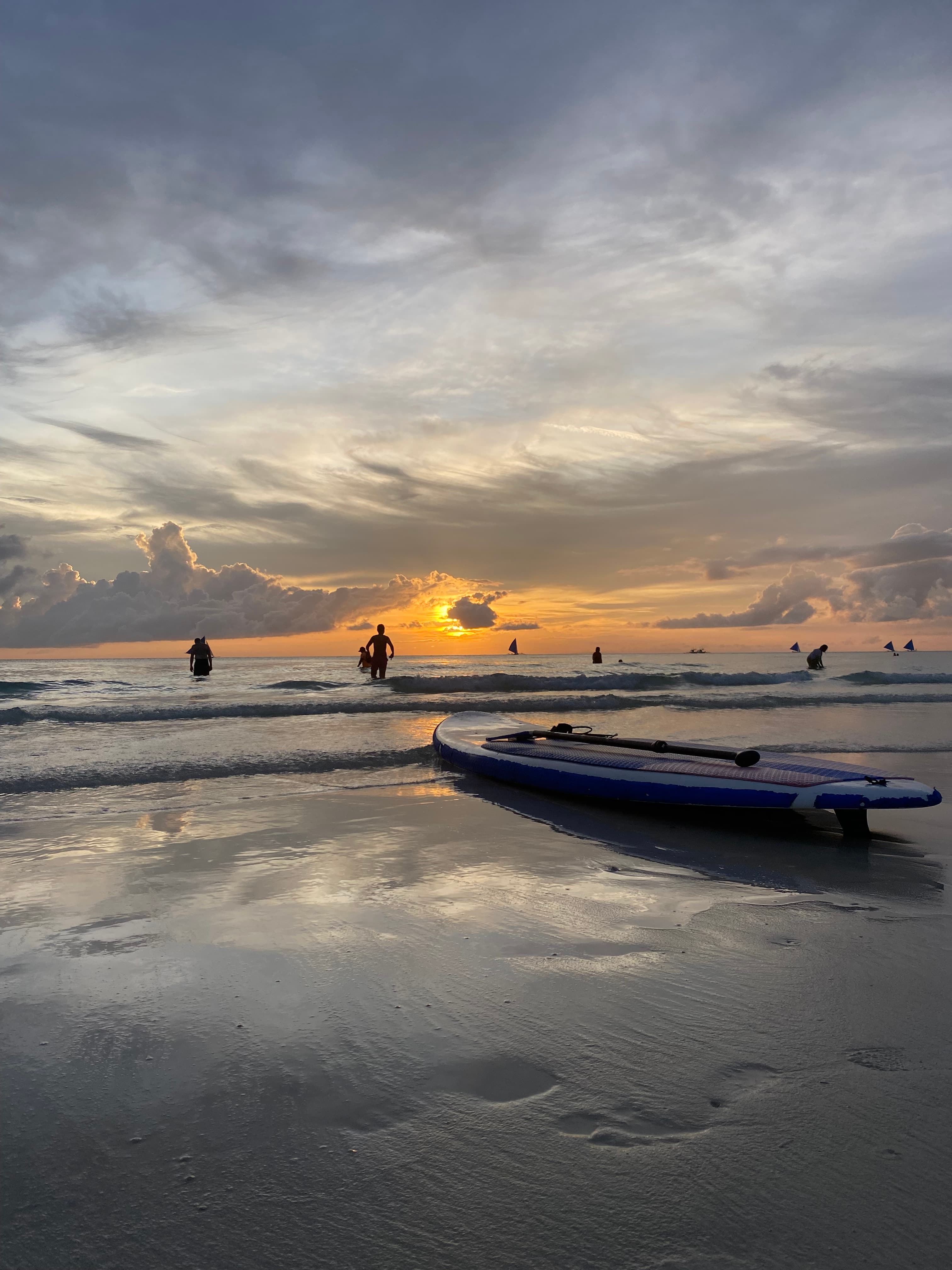 View of the sunset on the beach with small waves rolling on shore