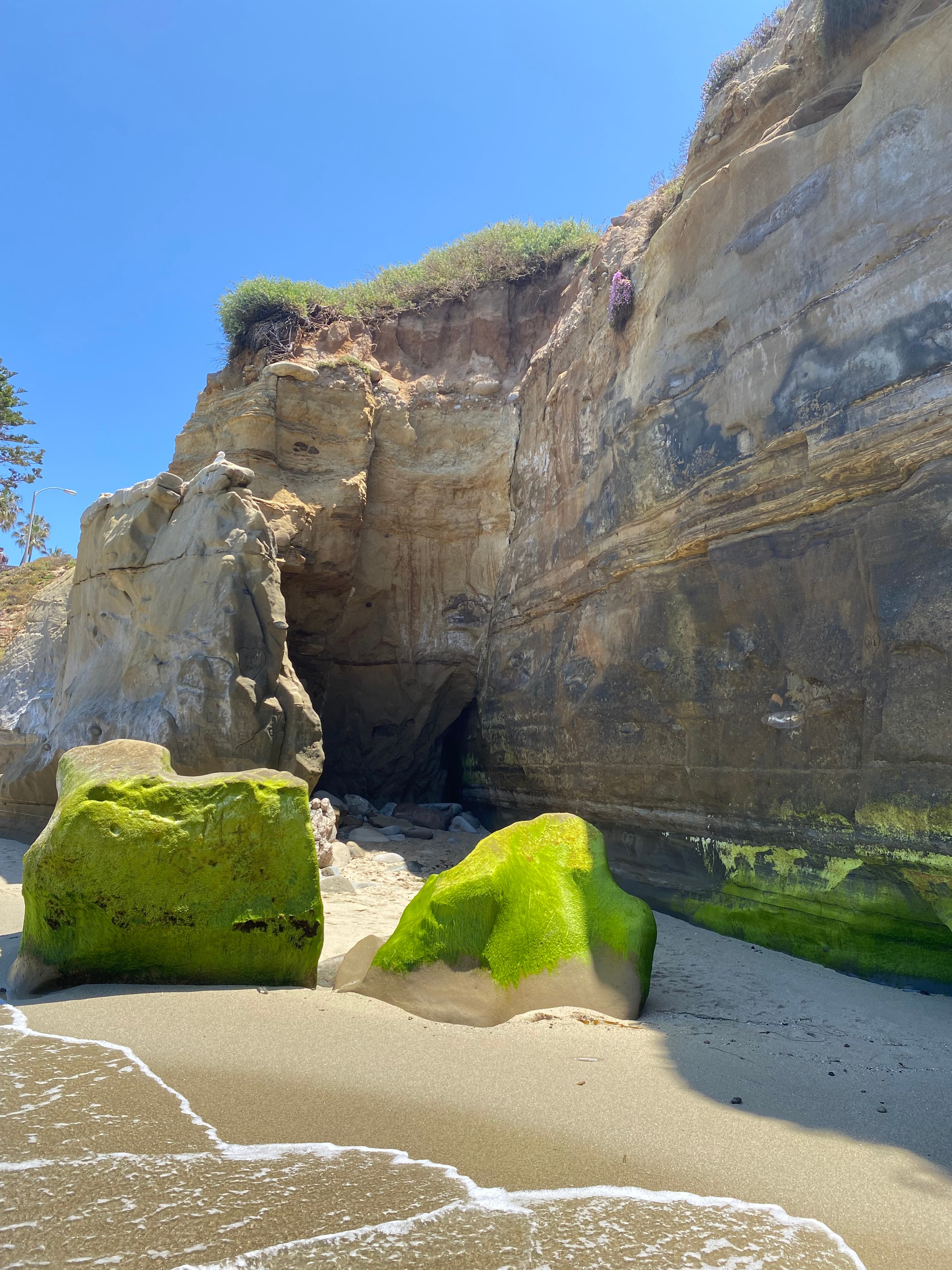 View of a rock formation on the beach on a sunny day