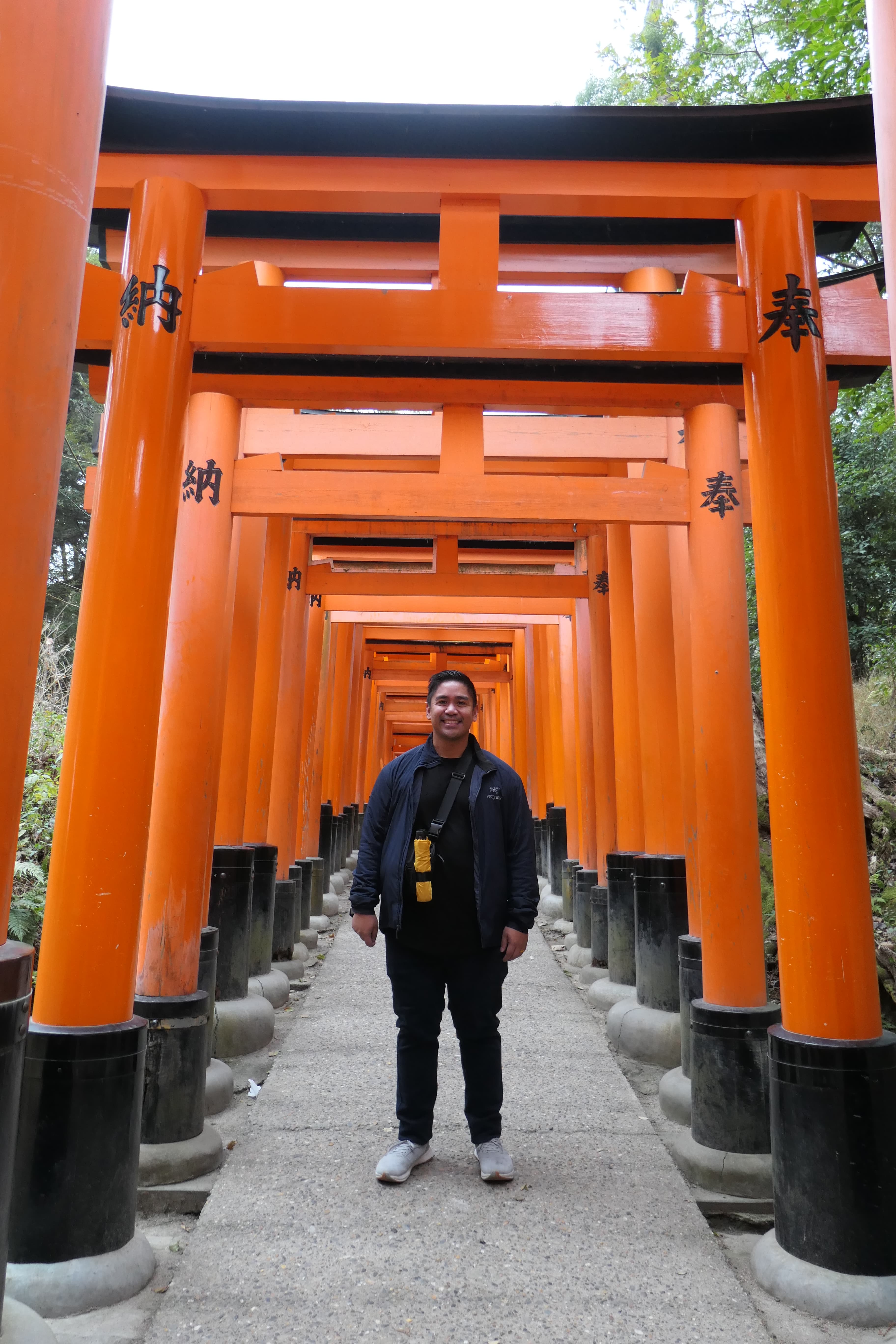 A person standing under an orange structure