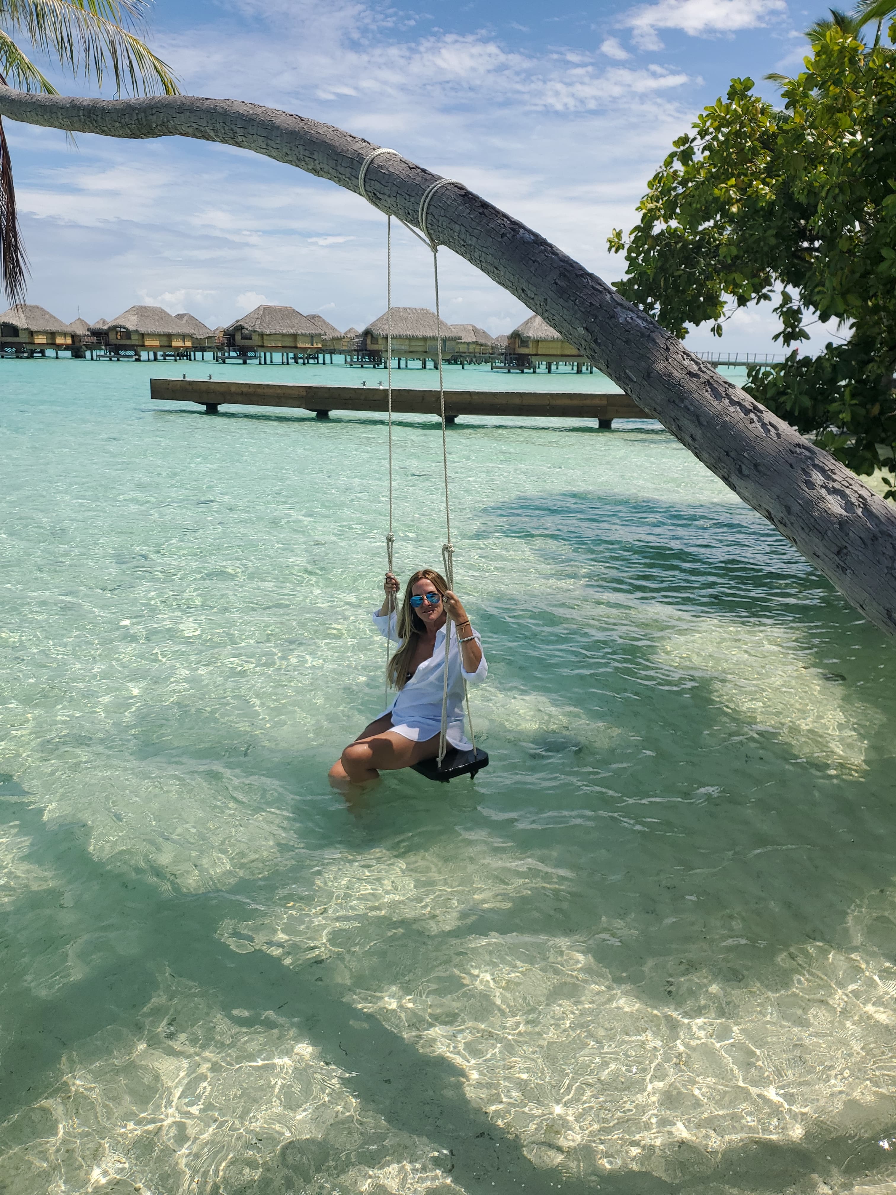 Advisor posing on a swing over open waters on a clear day. 