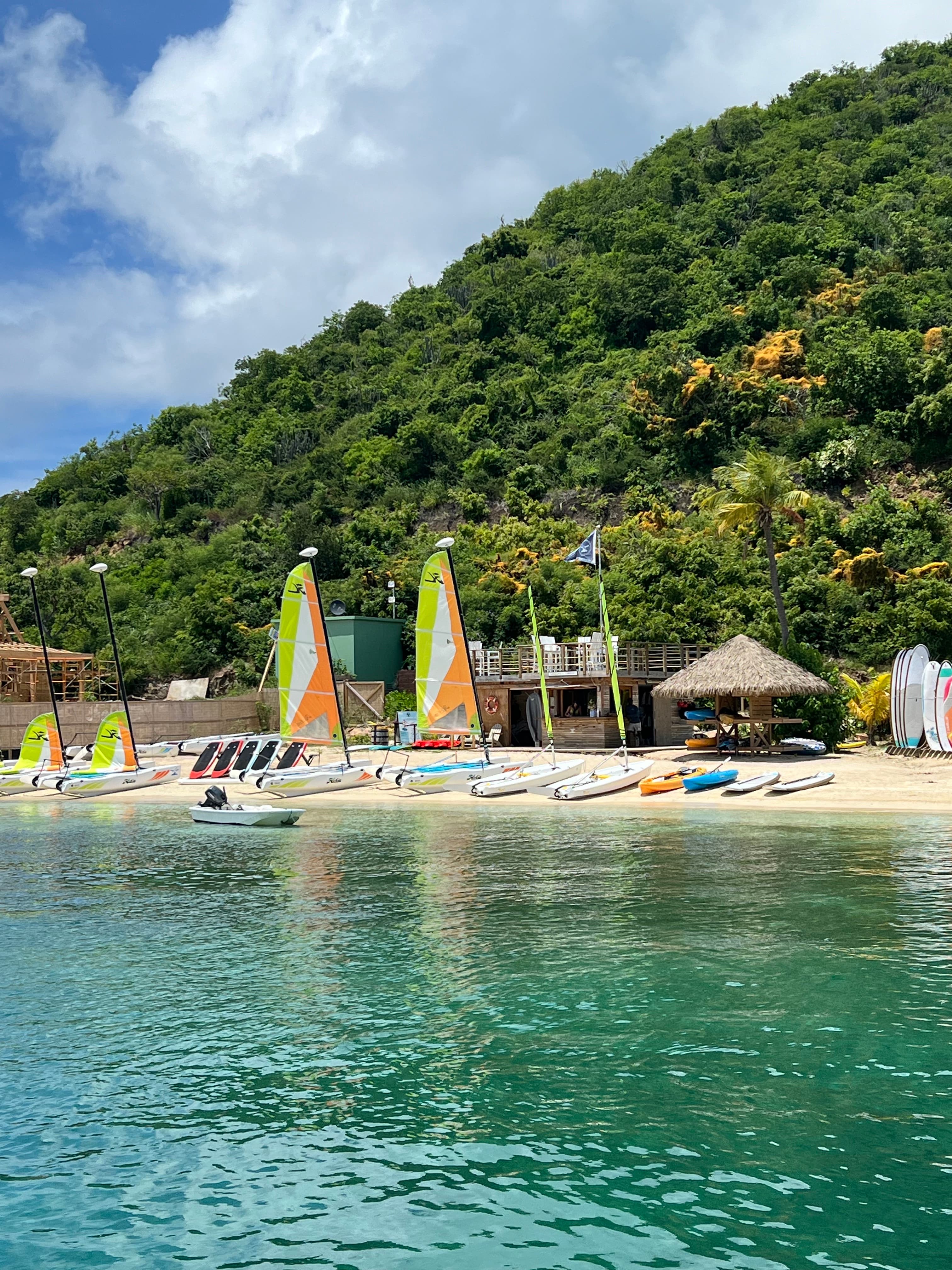 View of a small boats on a small white sand beach and a calm sea