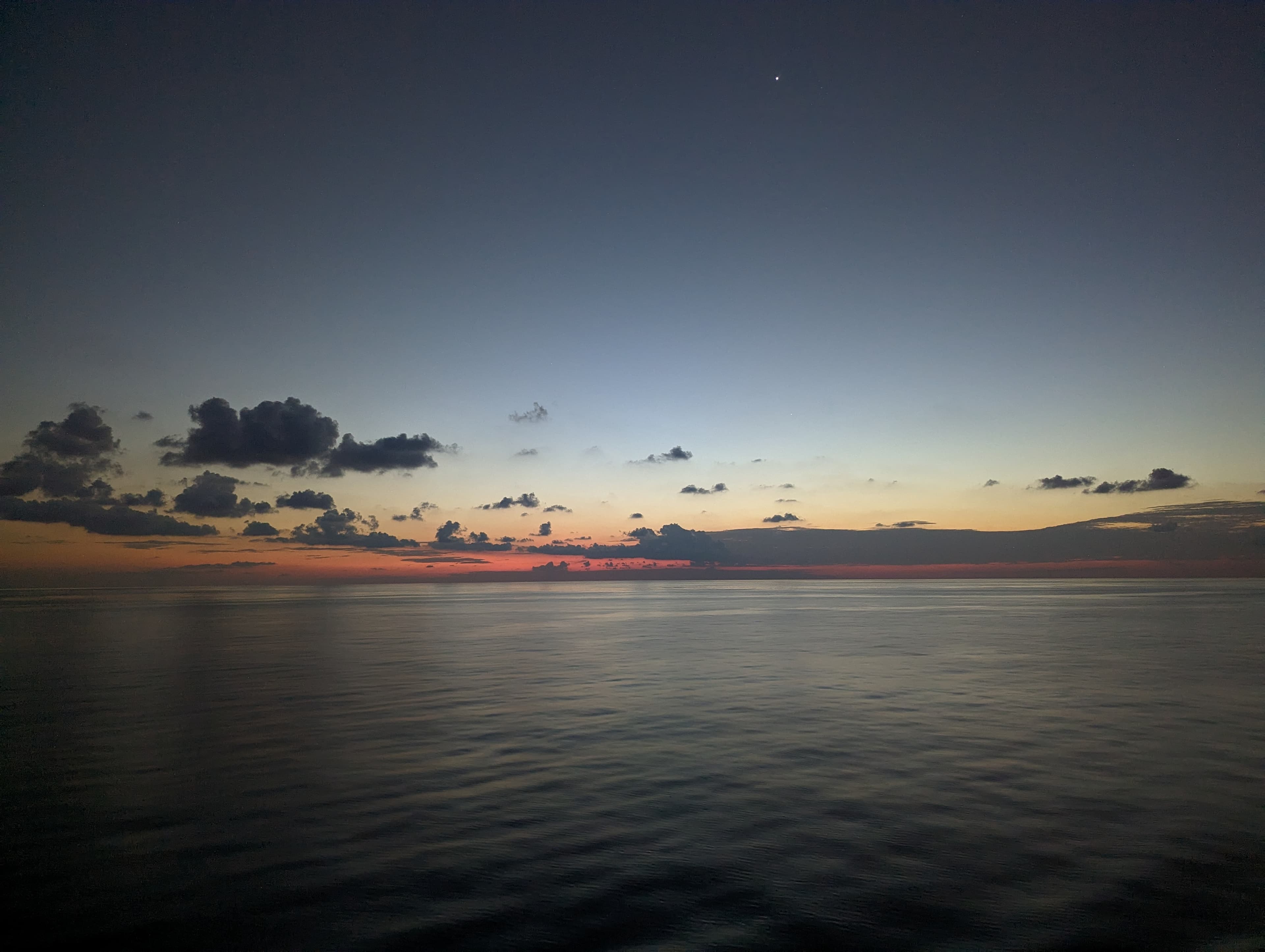 View of the sunset over a flat ocean