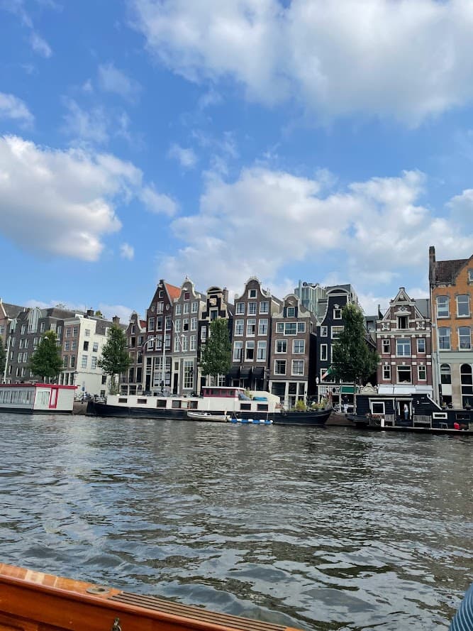 A vibrant view of Amsterdam showcasing its iconic canals and historic architecture, reflecting the city's unique charm.