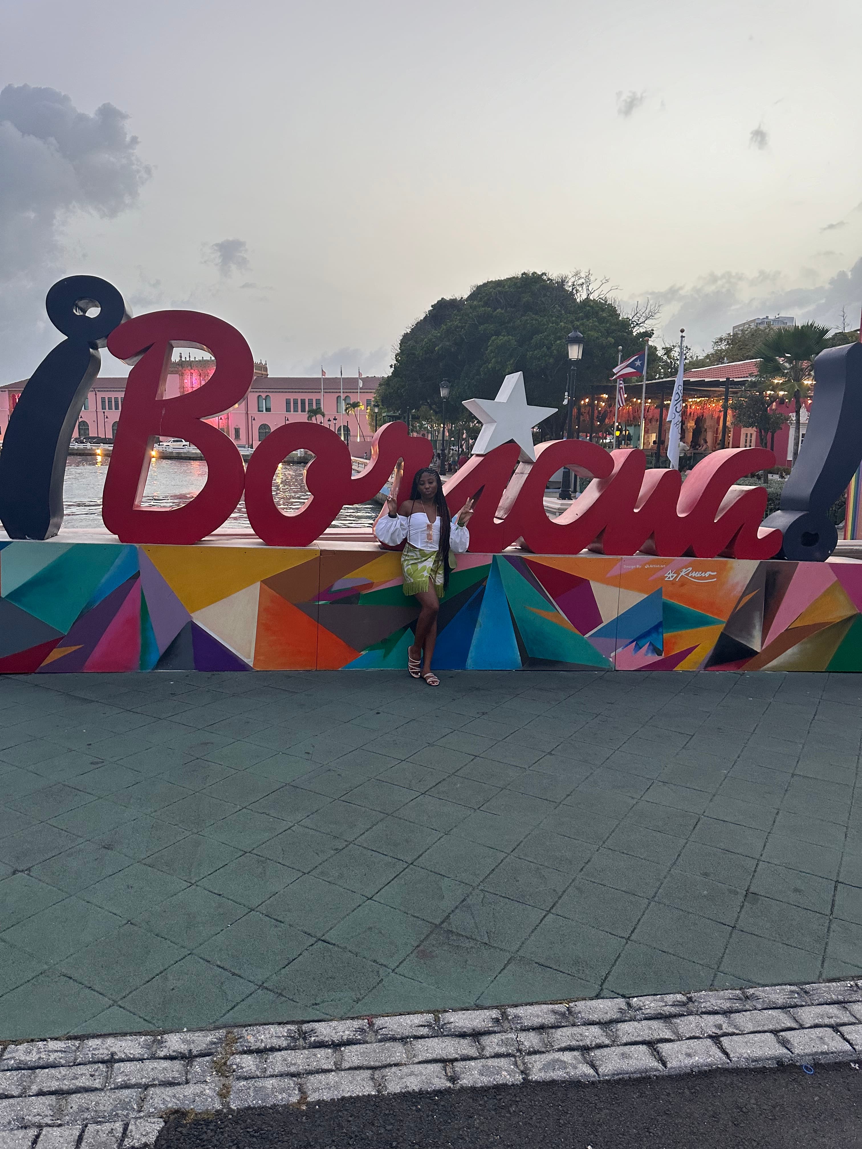 Advisor posing near a tourist sign at dusk. 