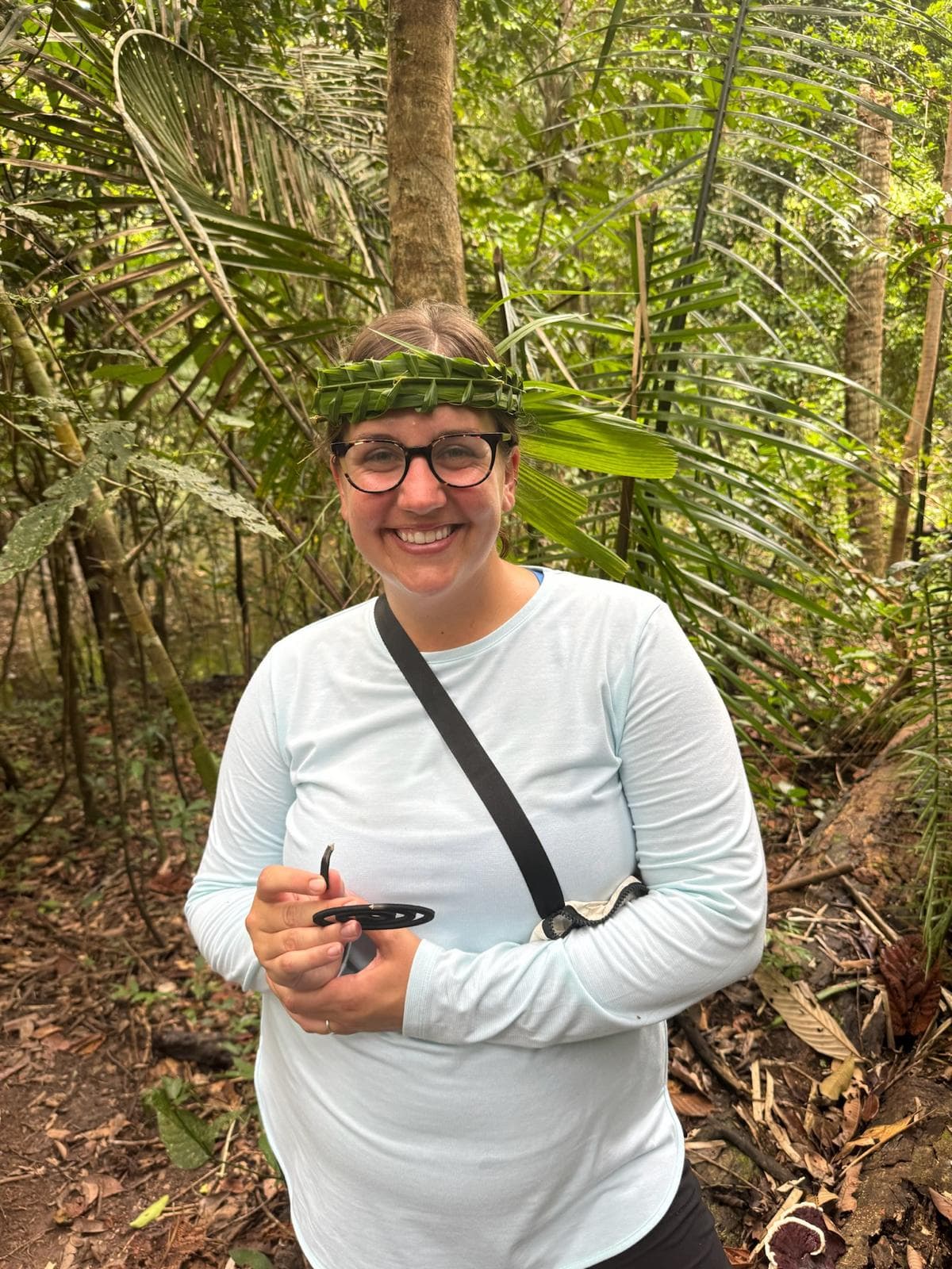 Advisor with a green bandana on their head in the woods