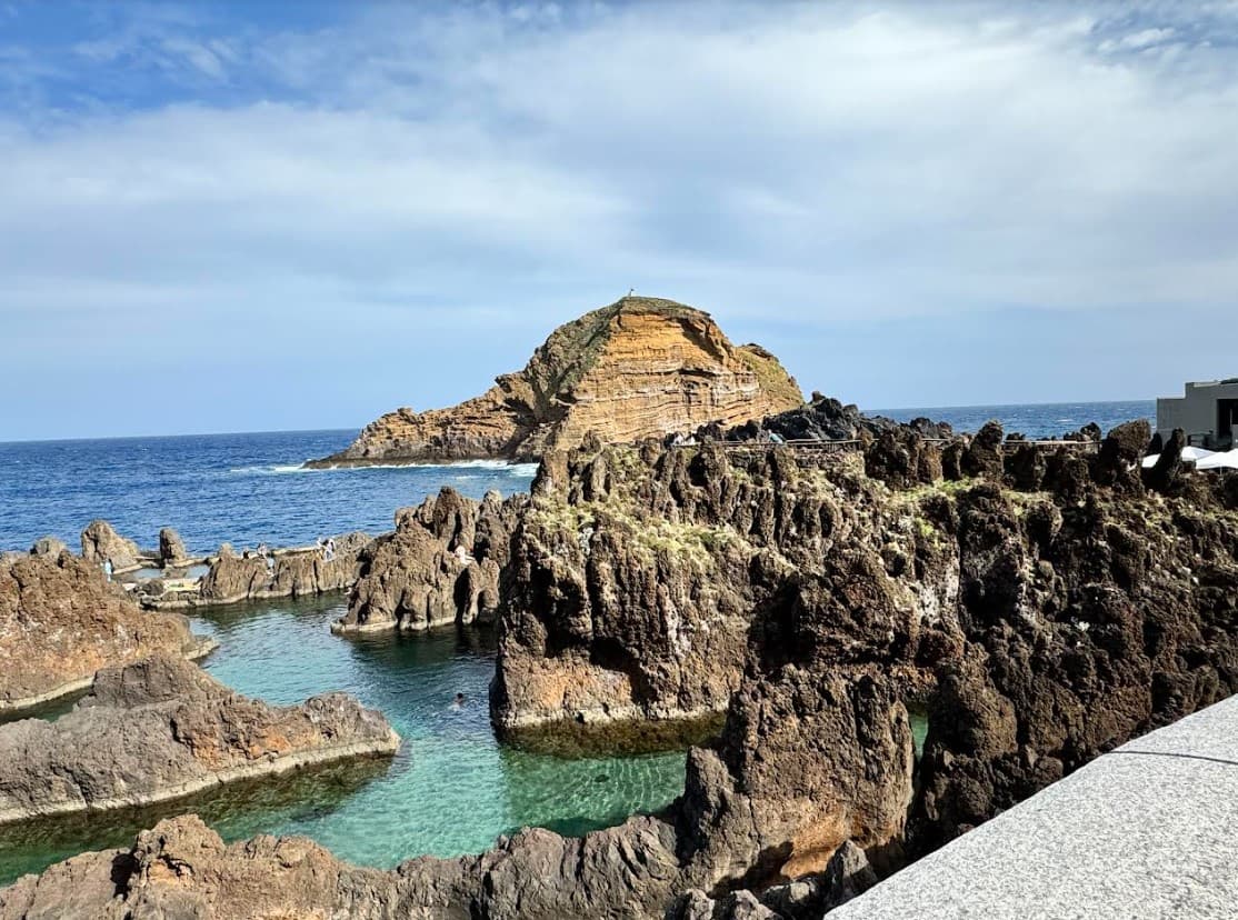 View of rock formations along the coast on a sunny day