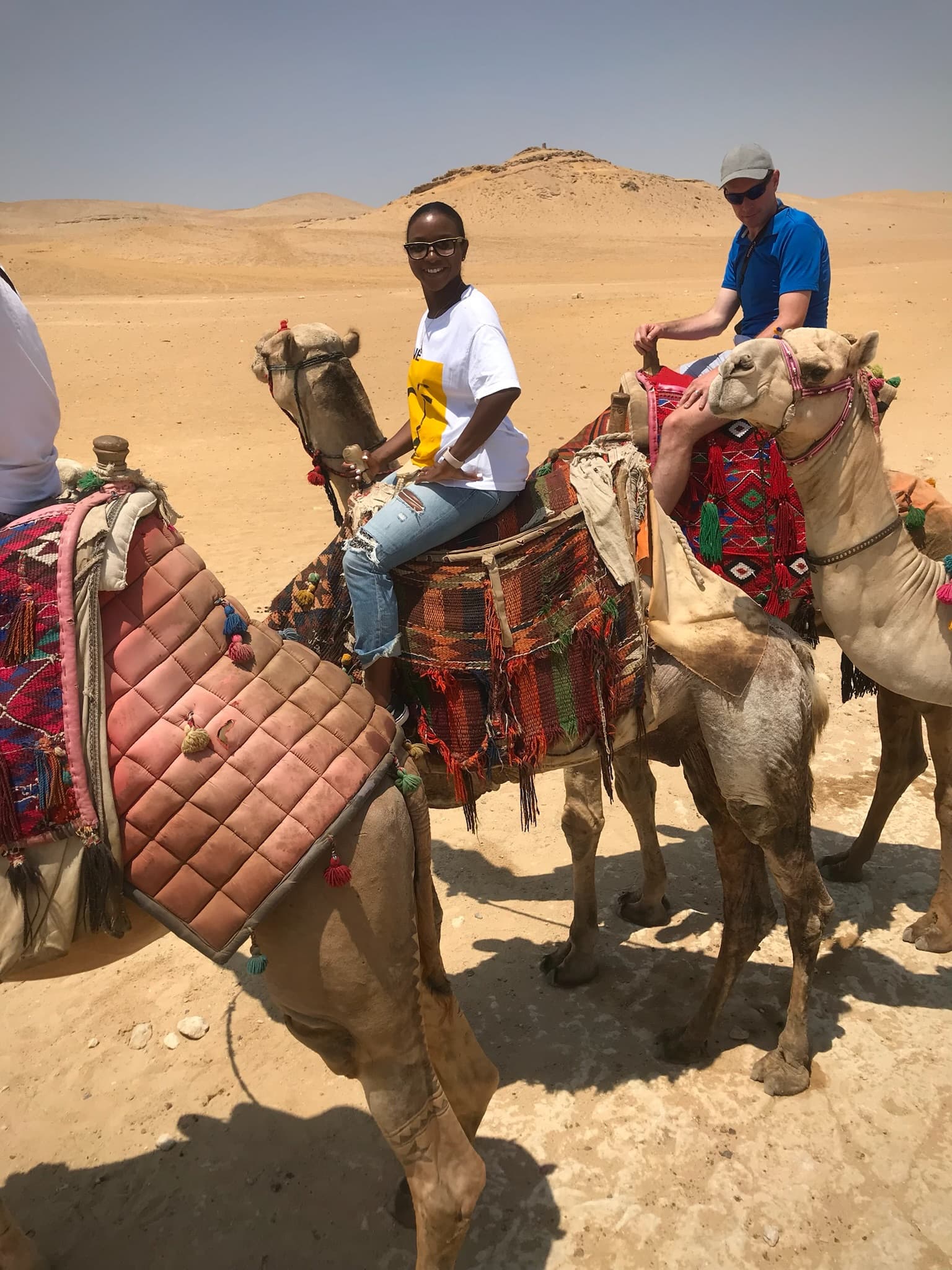 View of advisor on a camel’s back in the desert on a sunny day