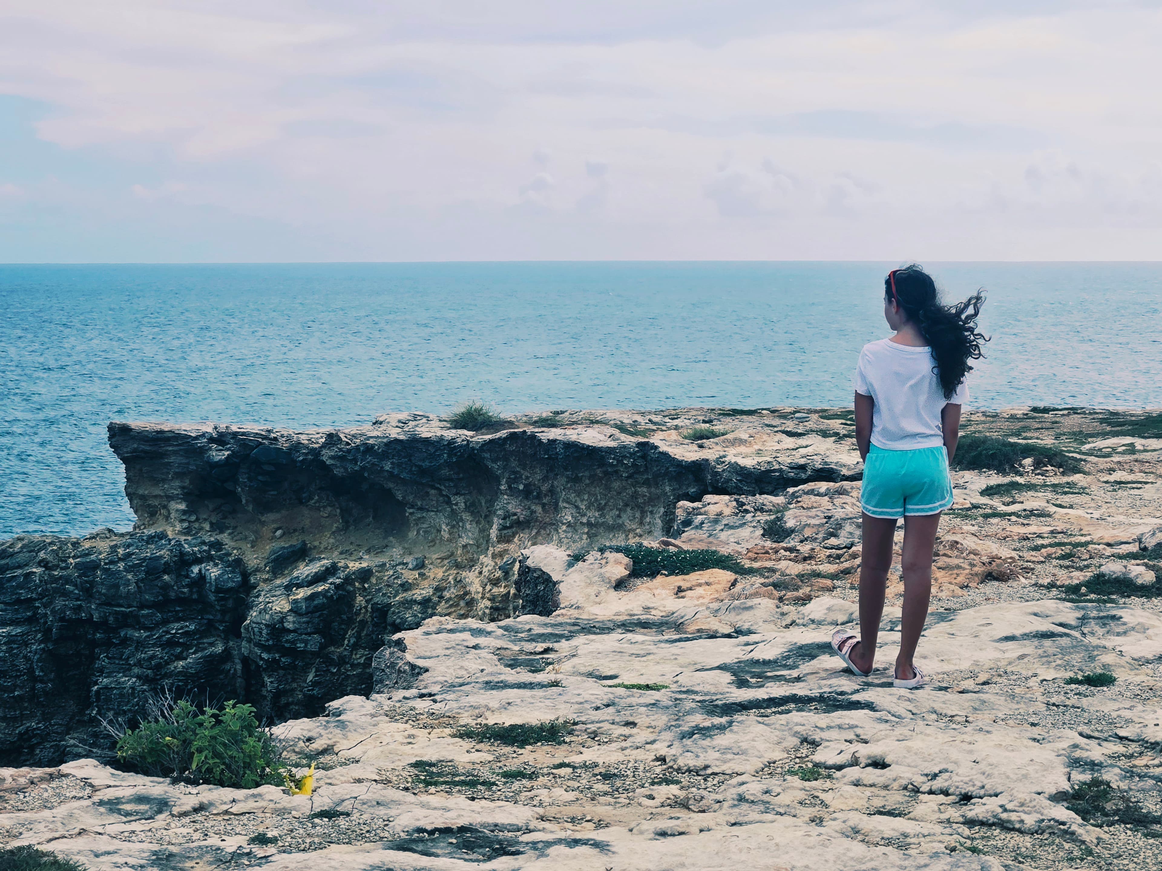 Standing by cliff edge.