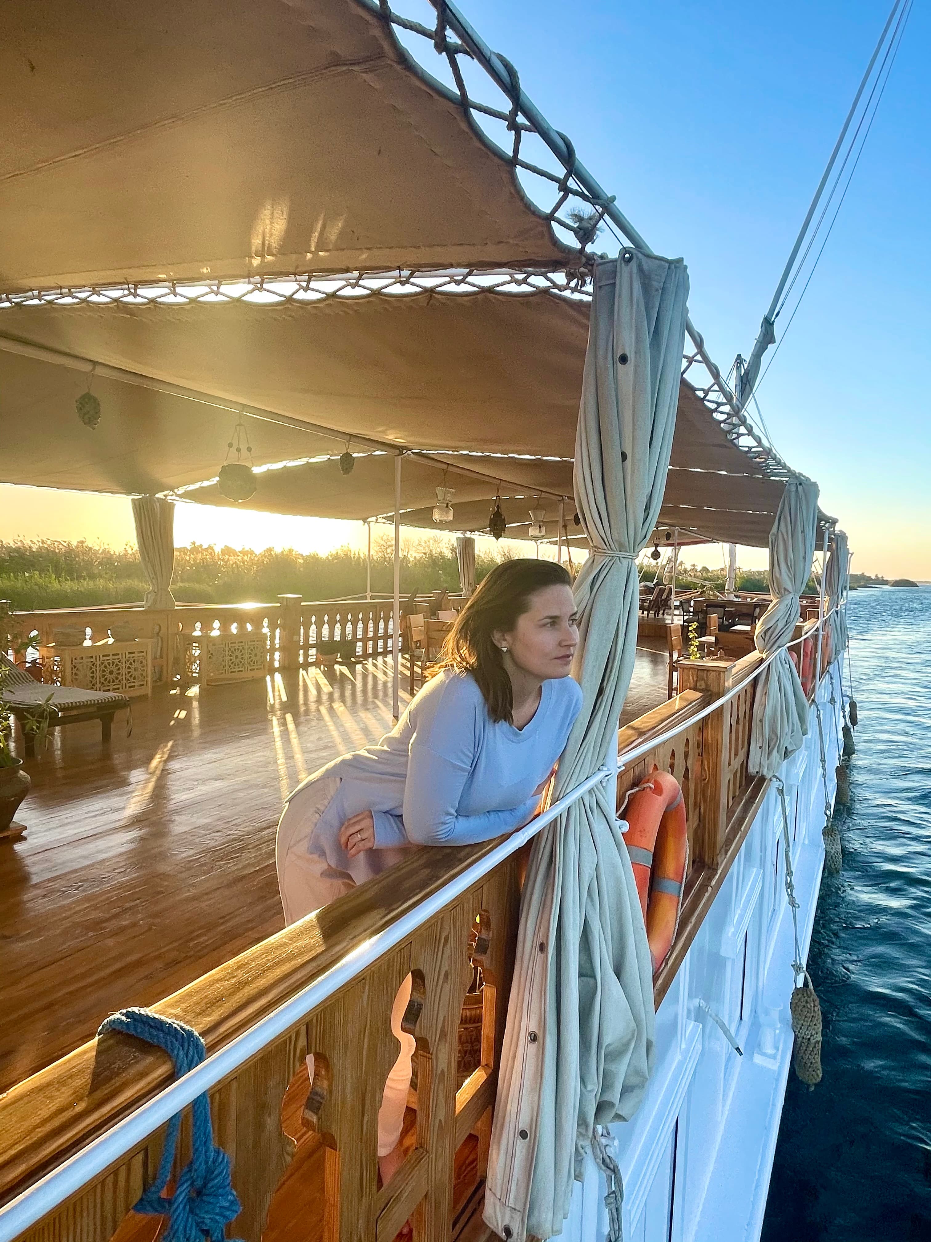 Image of advisor on a yacht at dusk with the ocean in the distance. 