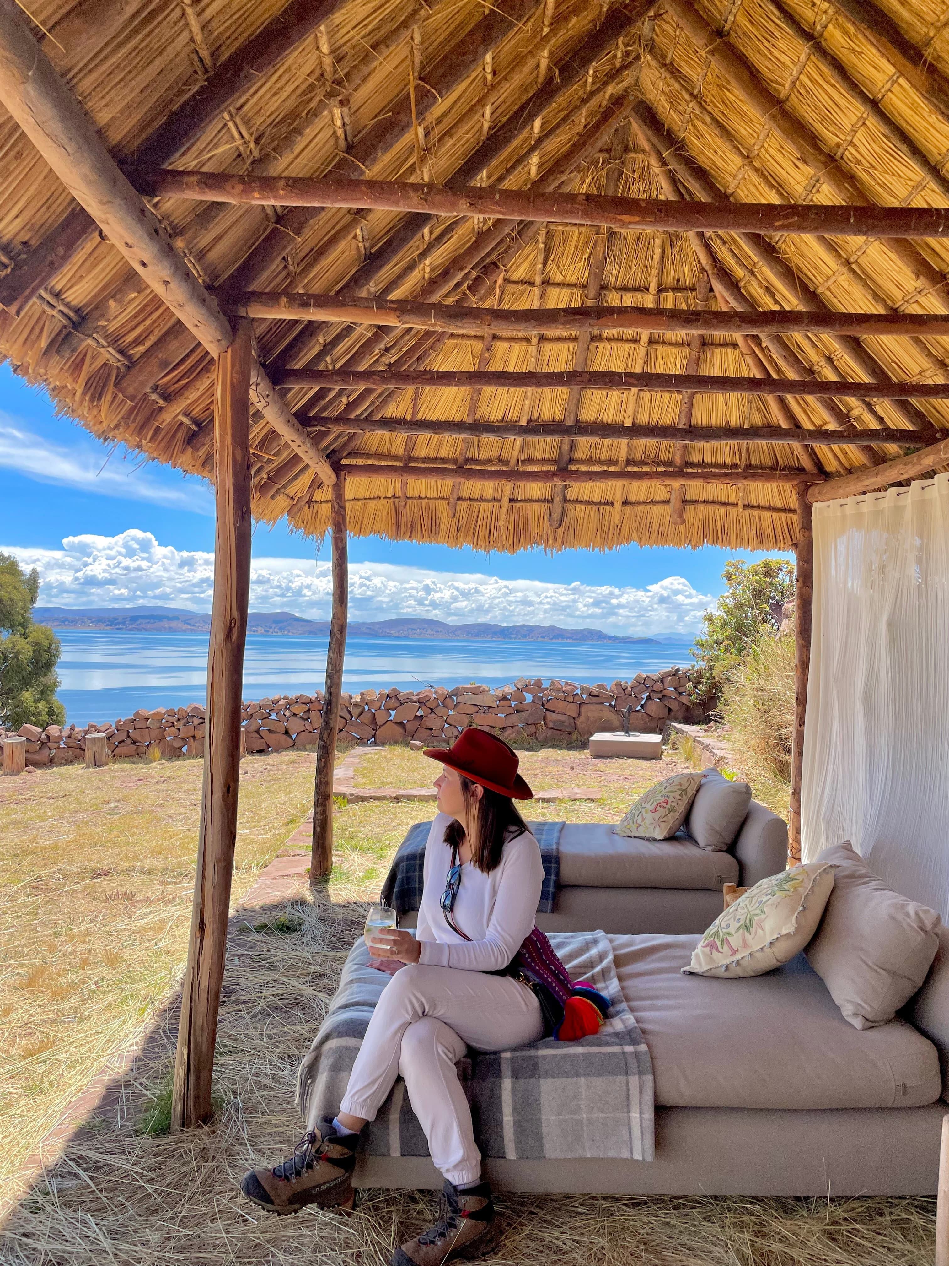 Advisor posing on an outdoor balcony wiht the desert and clouds in the distance. 