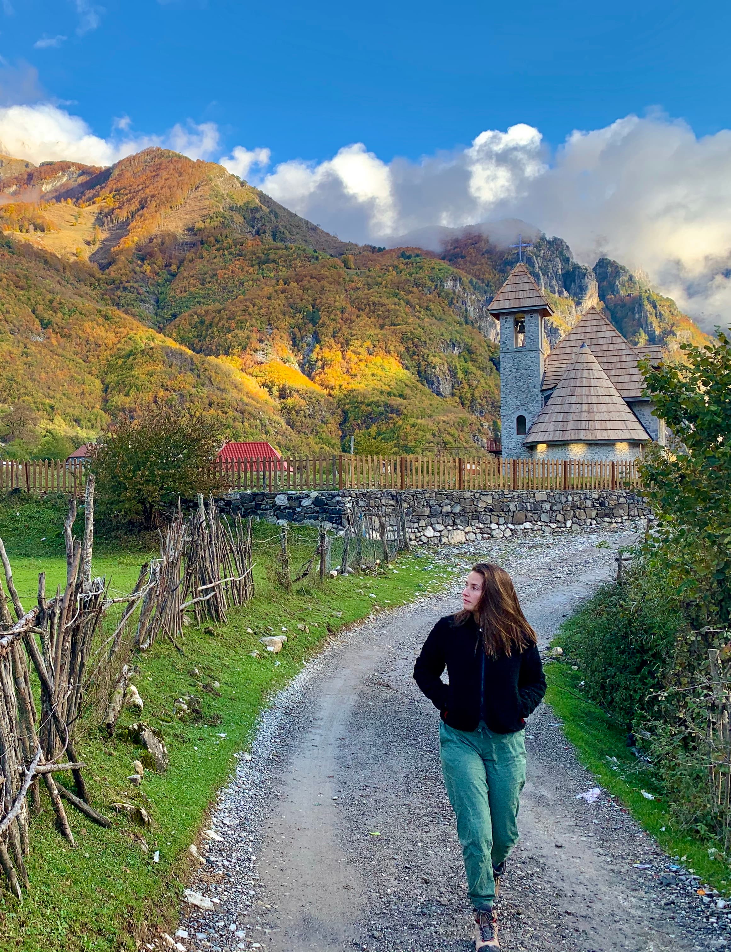 Advisor on a walking path towards a town with nature in the distance on a sunny day. 