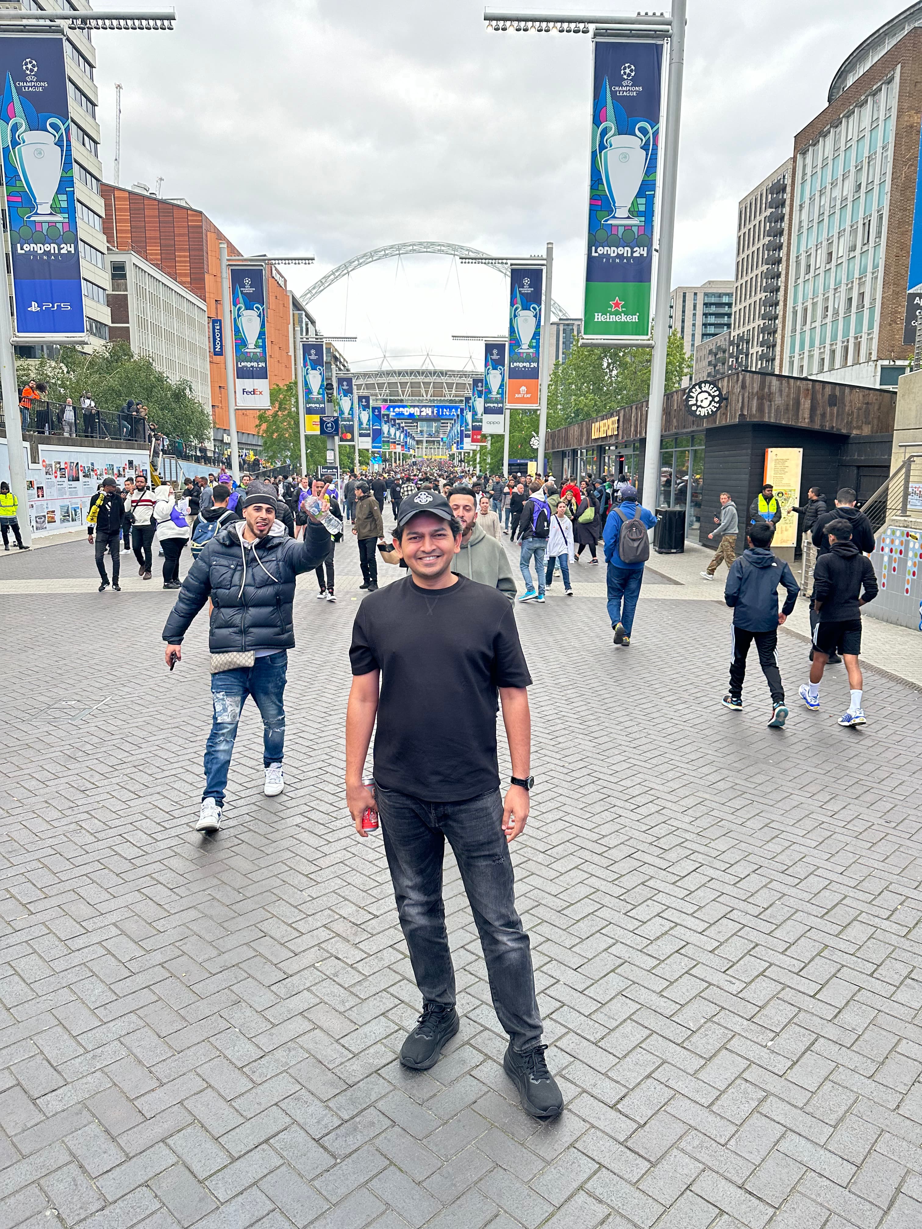 Advisor standing on a wide city street with pedestrians walking nearby