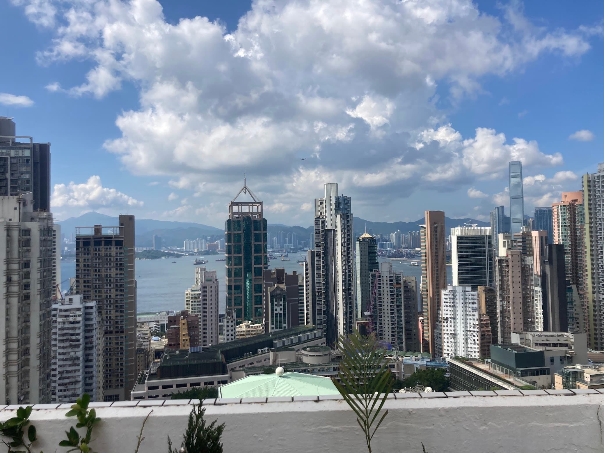 Rooftop view of a modern city skyline with many high-rise buildings on a sunny day