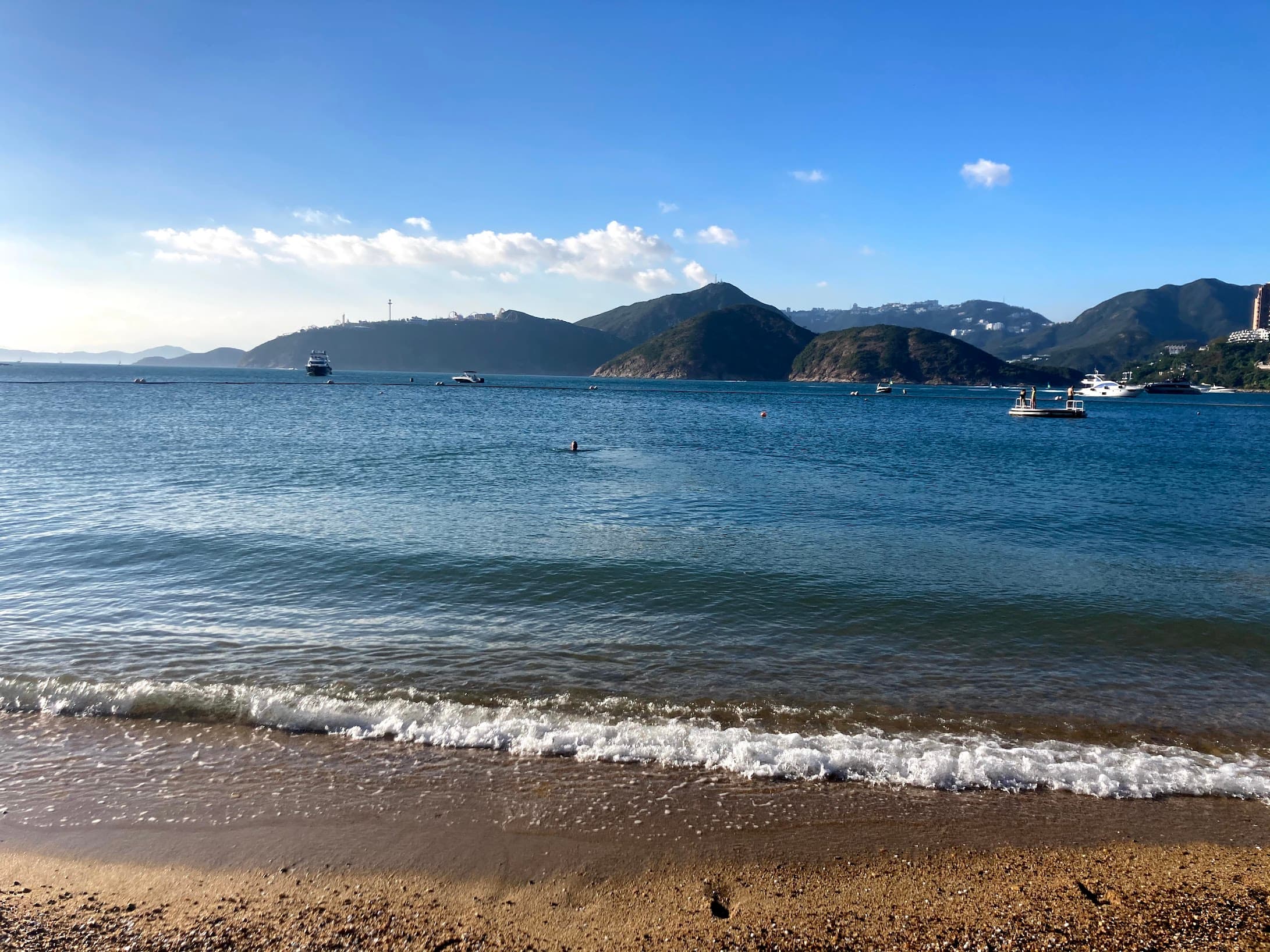 View of the ocean and mountains visible across the bay on a sunny day