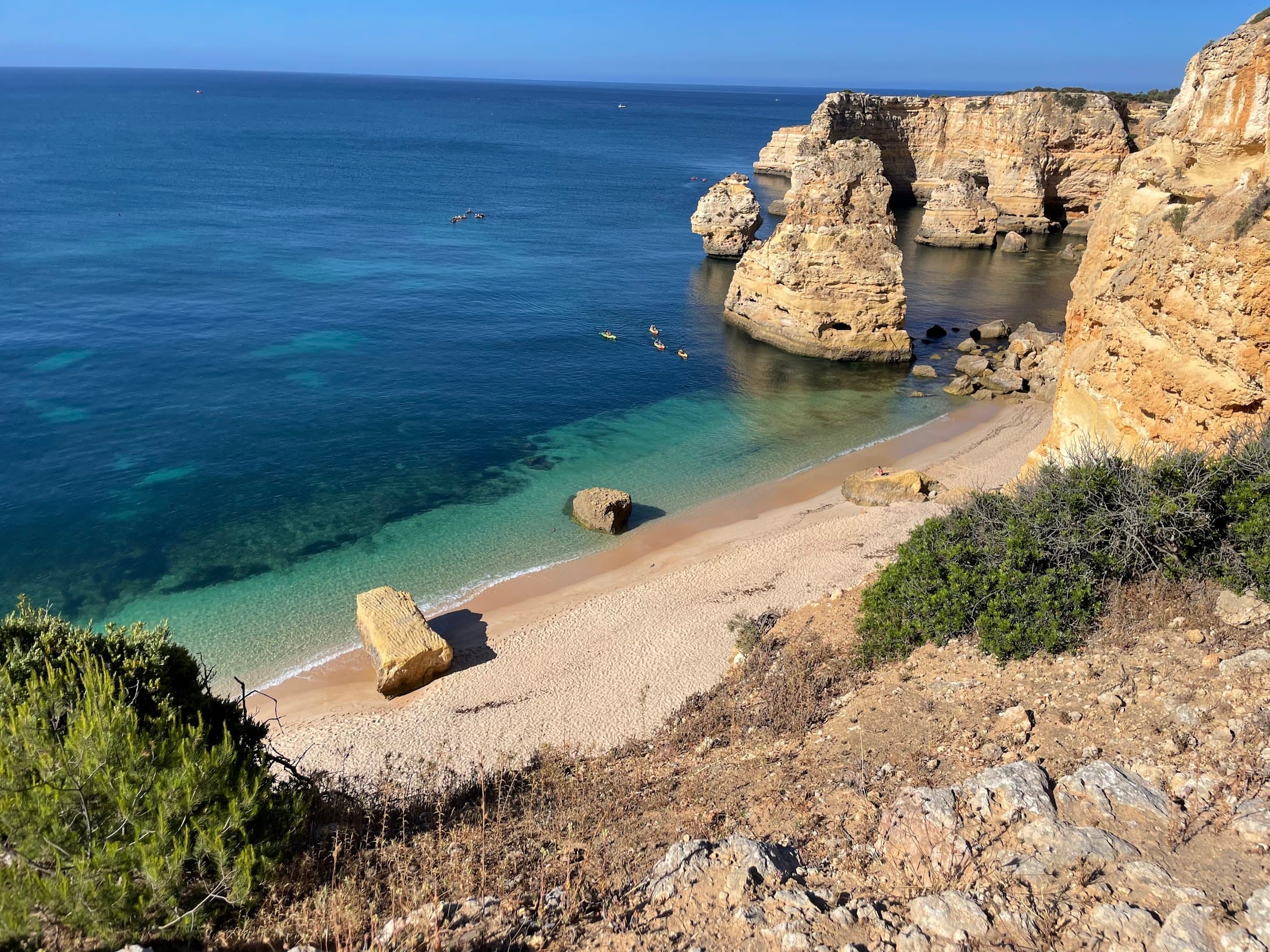 Overhead view of an empty and secluded beach lined with steep cliffs