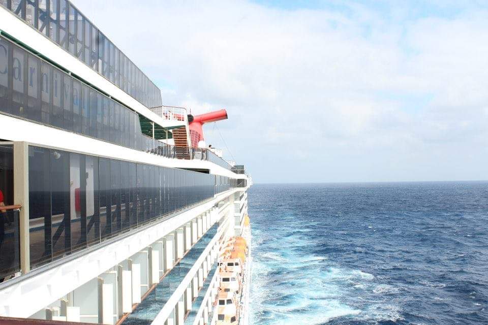 View of the side of a ship at sea on a sunny day