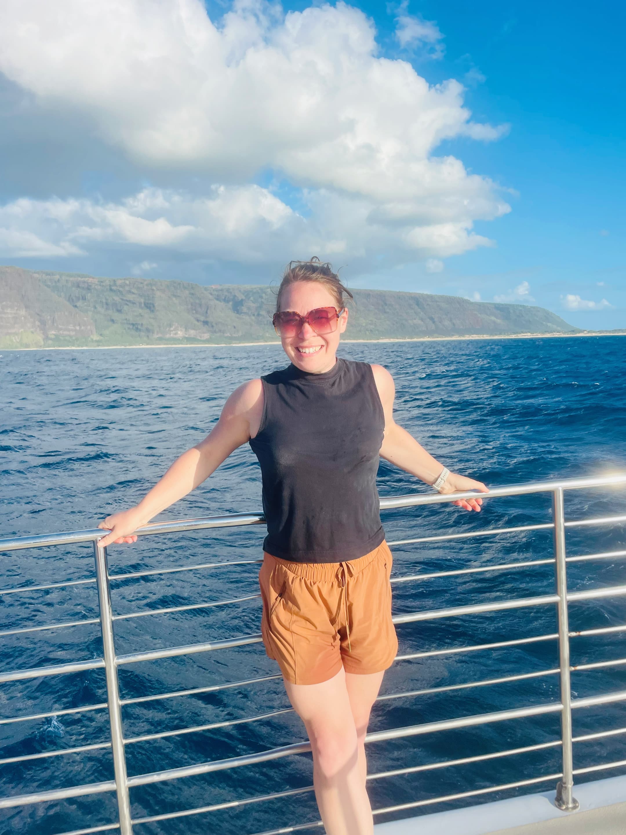 Advisor posing on the side of a ship on a sunny afternoon