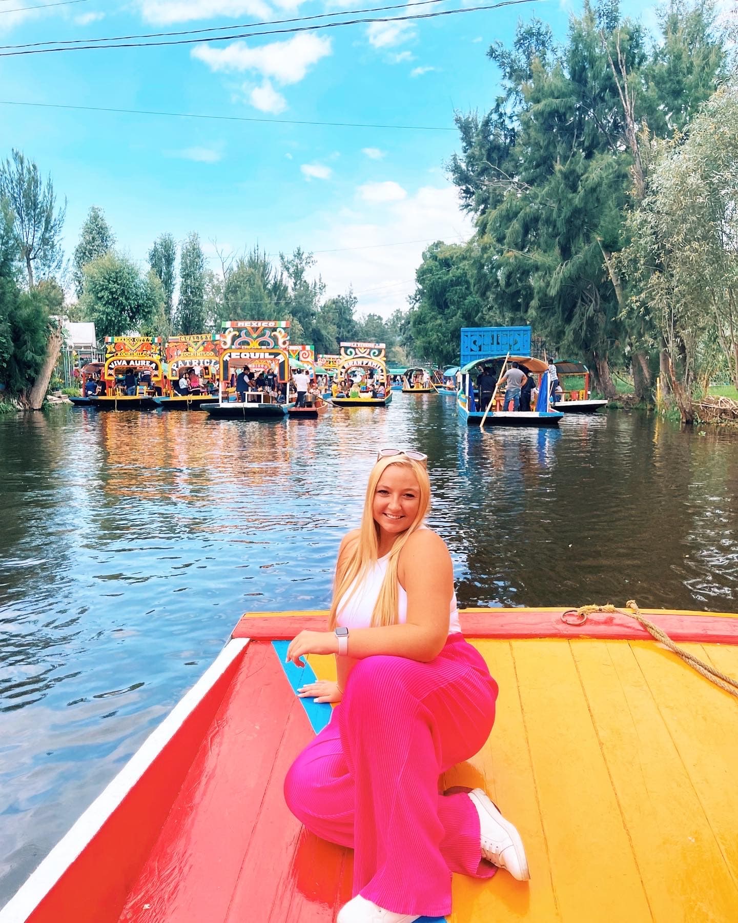 Advisor posing for an image on a colorful raft in the water on a sunny day.