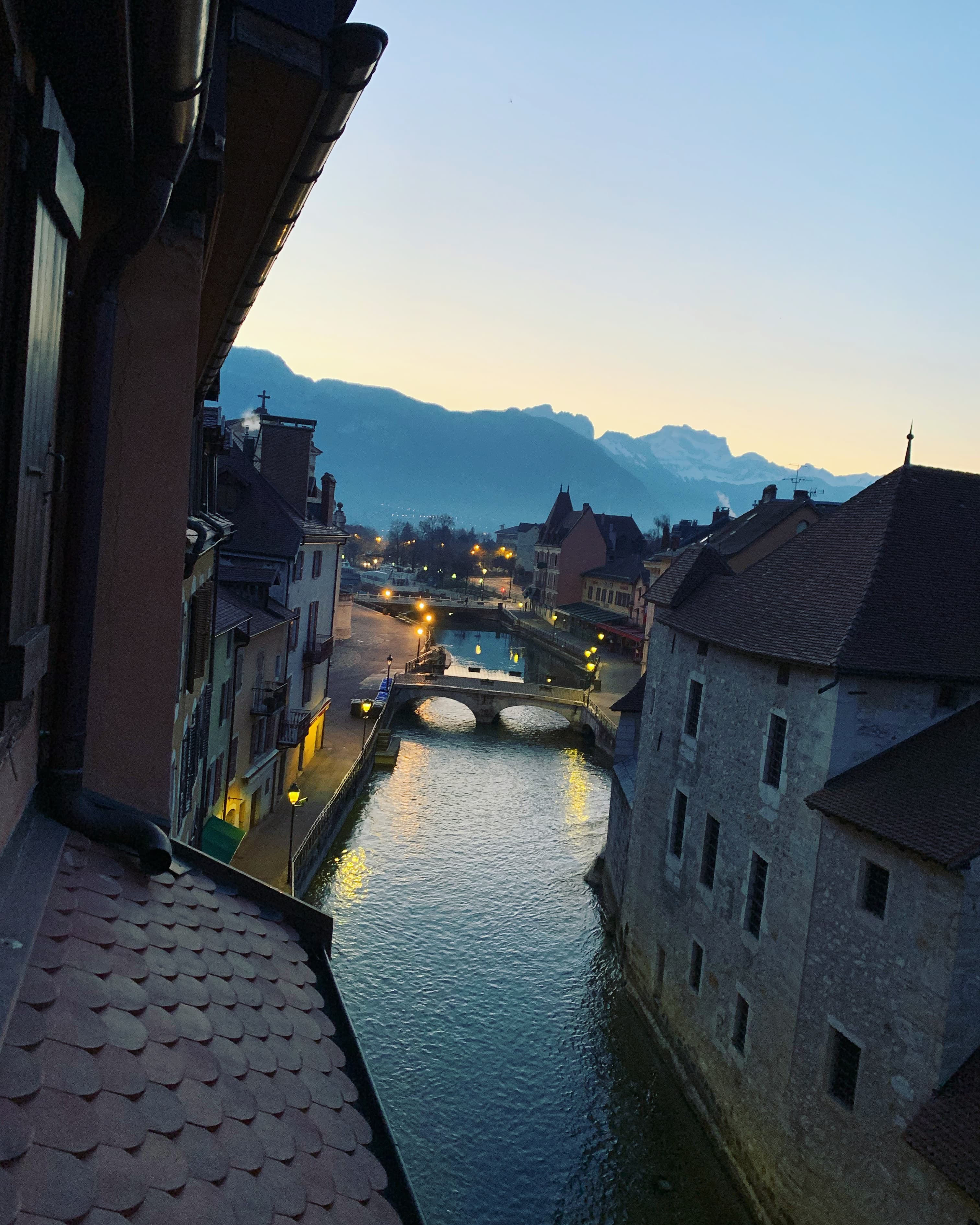 A water canal between buildings during a sunset