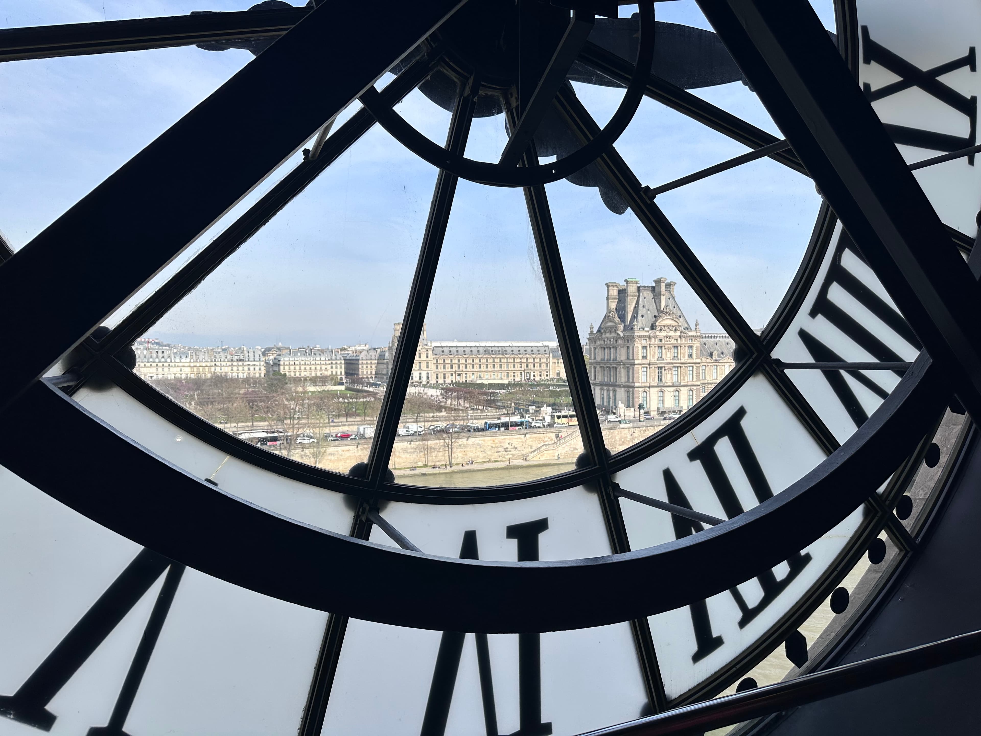 The backside of a clock in a tower during the daytime