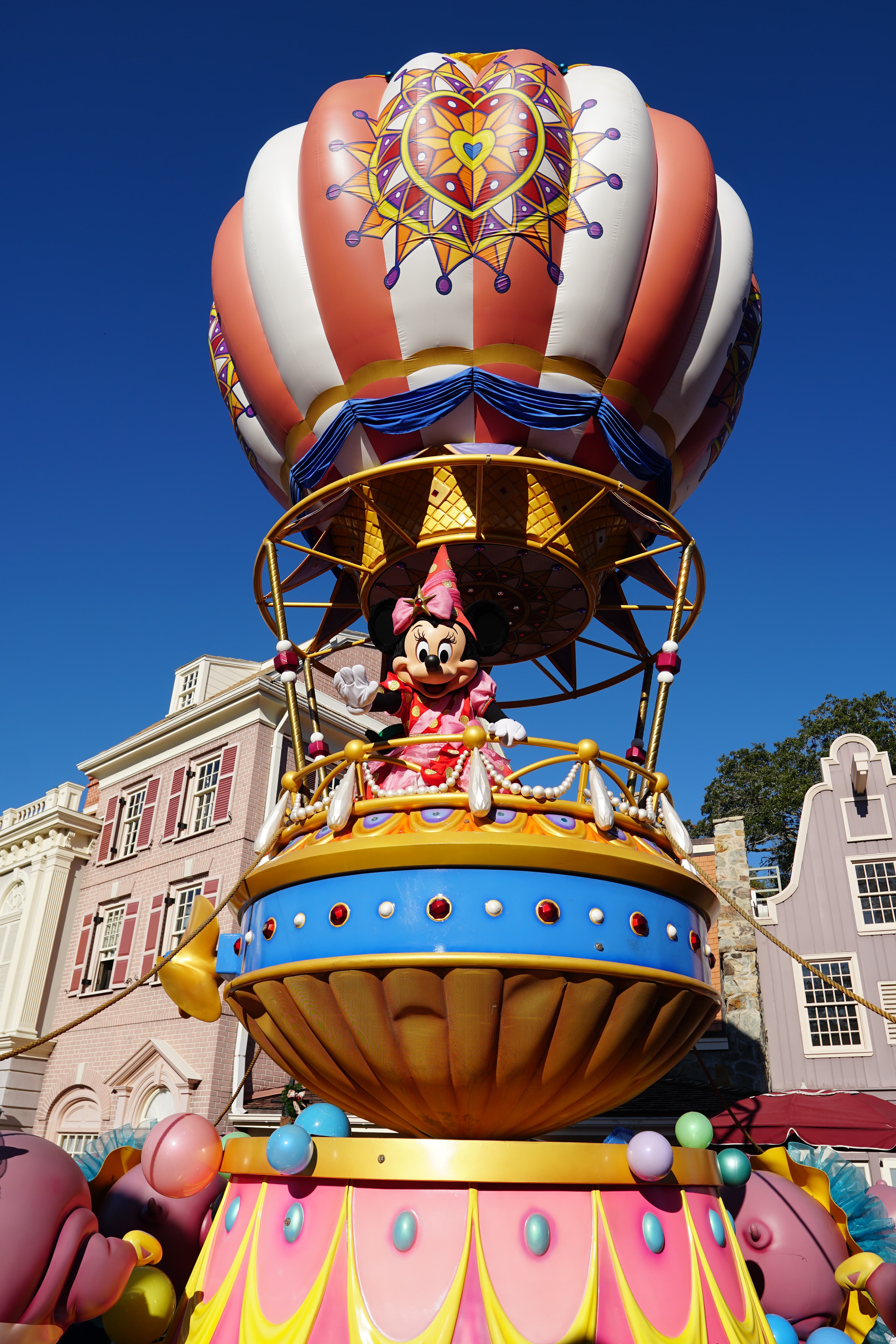 View of a hot air balloon float with Minnie Mouse waving on a sunny day
